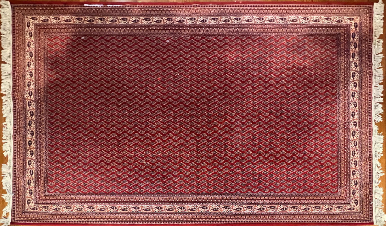 BELGIAN WOOL RUG: With label under one corner. Dimensions: (Incl. fringe) L 137" x W 94" Condition: Light wear from use.