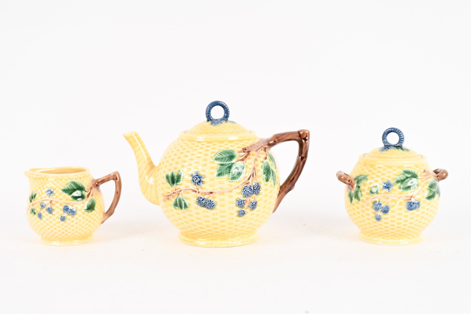 TIFFANY & CO. MAJOLICA TEA SERVICE: Includes teapot, creamer and covered sugar bowl. Marked underneath Tiffany & Co. / Made in Portugal. Dimensions: (Teapot) H 6" x W 8.5" x D 6" Condition: No issues to note.