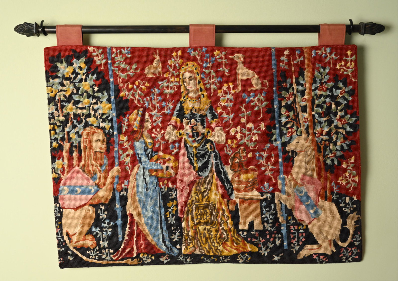 MEDIEVAL STYLE TAPESTRY: Rod with pinecone form finials. Dimensions: H 20" x W 30" x D 1" Condition: Very light signs of wear including some pulling to fabric holding onto rod.