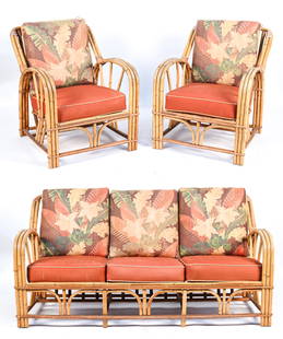 ART DECO BAMBOO RATTAN PATIO SEATING SUITE: Including a sofa and pair of lounge chairs. In the manner of Paul Frankl, c. 1930s-1940's. Dimensions: (Sofa) H 32" x W 65" x D 31" x SH 12.5" Condition: Cushions not original; with some soiling and s