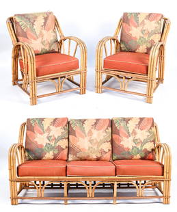 ART DECO BAMBOO RATTAN PATIO SEATING SUITE: Including a sofa and pair of lounge chairs. In the manner of Paul Frankl, c. 1930s-1940's. Dimensions: (Sofa) H 32" x W 65" x D 31" x SH 12.5" Condition: Cushions not original; with some soiling and