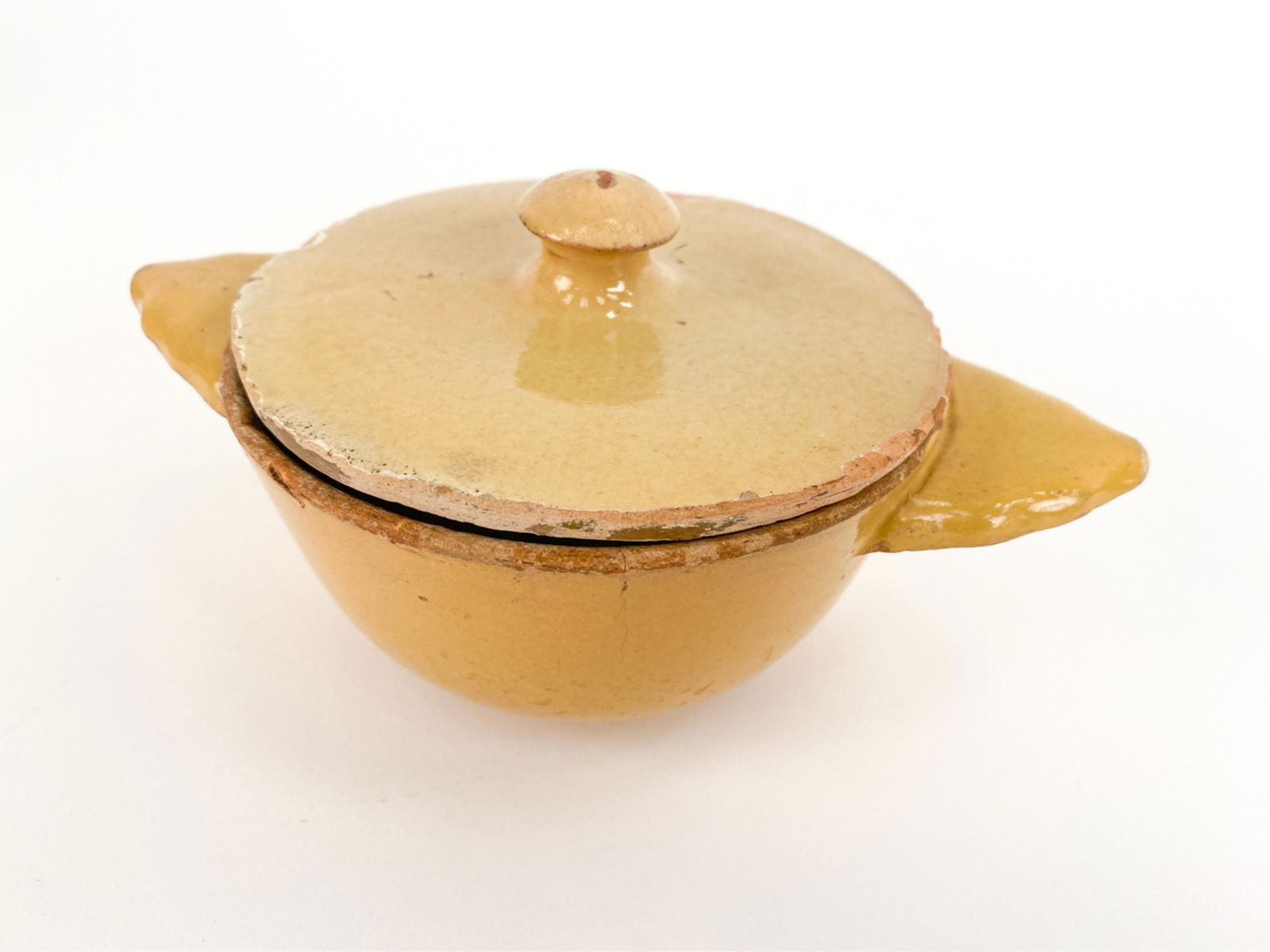 FRENCH ANTIQUE SAVOIE BUTTER DISH: Original lid and Savoie-style bowl made for preserving butter in the kitchen. With long handles known as "oreilles a buerre (butter ears)." Dimensions: H 4" x W 7.25" x D 4.5" Condition: Crack emanati