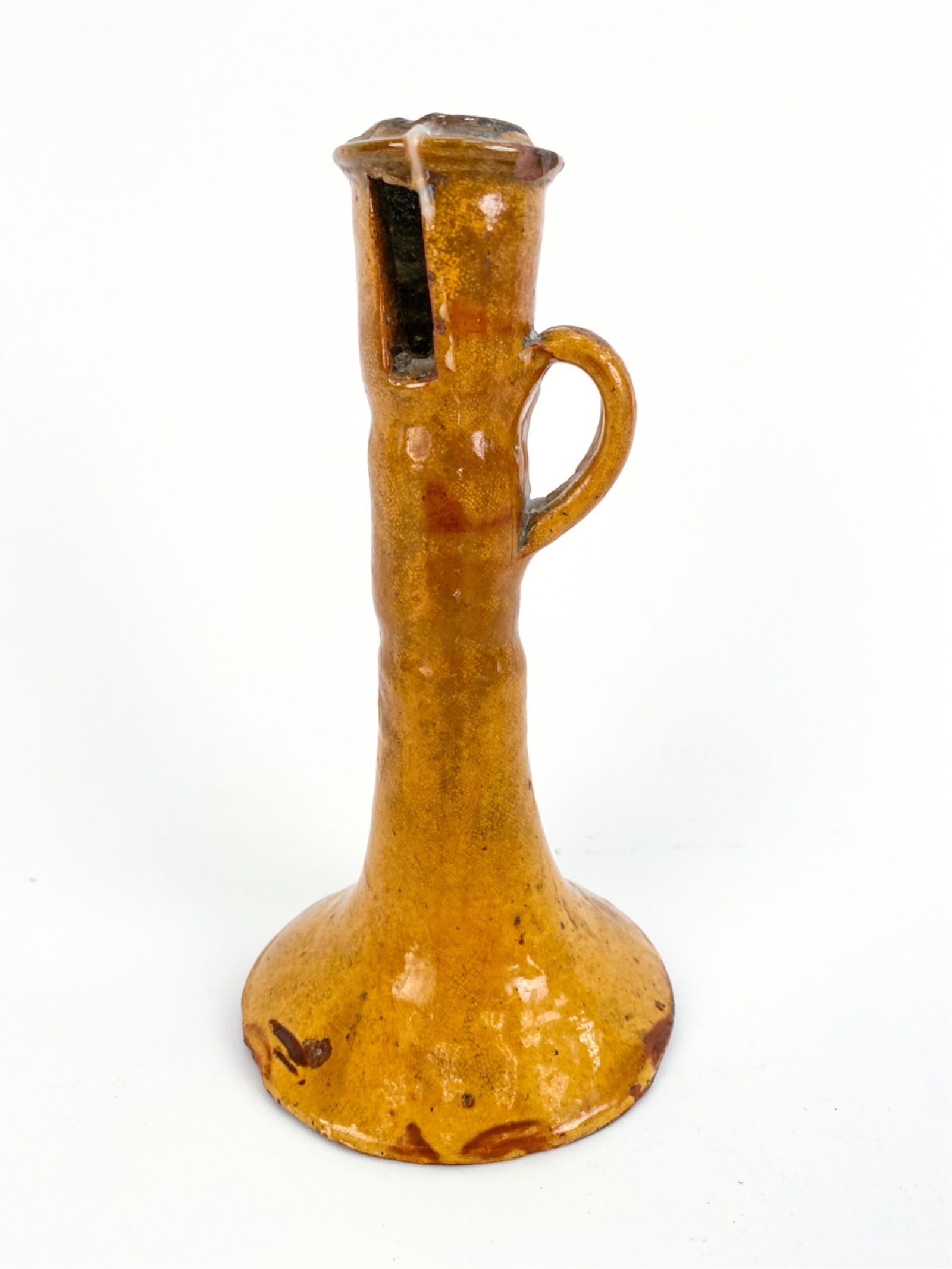 18TH C. FRENCH ANTIQUE CANDLESTICK: Only found in the Savoie, these candlesticks kept the flame lit for hours by applying oil in the opening below the rim. Dimensions: H 8.25" x Dia. 4.25" Condition: Large losses, particularly to base.