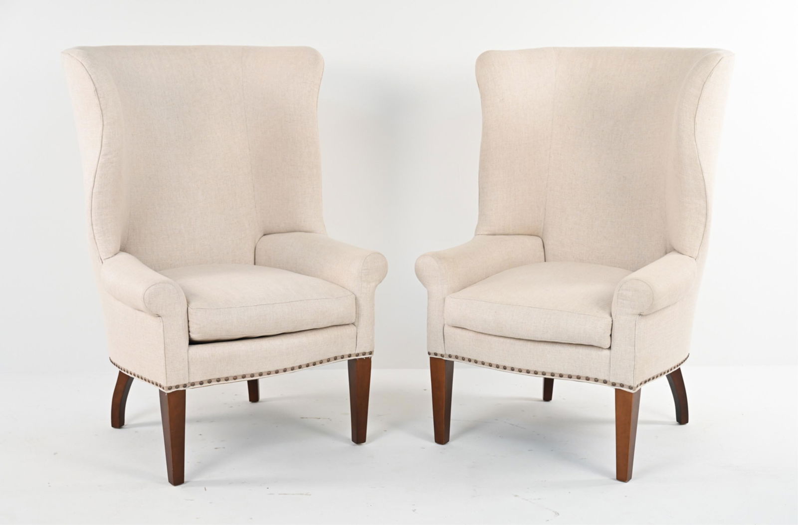 (2) MR. & MRS. HOWARD FOR SHERRILL WINGBACK CHAIRS: "Throwback" armchairs by Mr. and Mrs. Howard for Sherrill Furniture, in woven raw linen, labeled underneath. Dimensions: H 48" x W 32" x D 29" x D 20" Condition: Linen with spots of soiling, a few pul