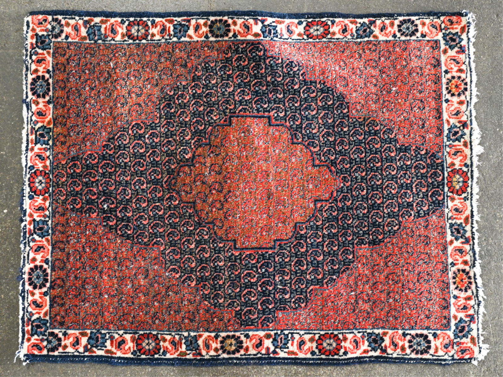 HAND-KNOTTED SENNEH MAT OR SAMPLER RUG: Dimensions: L 32" x W 25" Condition: Needs cleaning; surface dirt and soiling. Sun fading, some fraying and losses to binding; losses to fringe.
