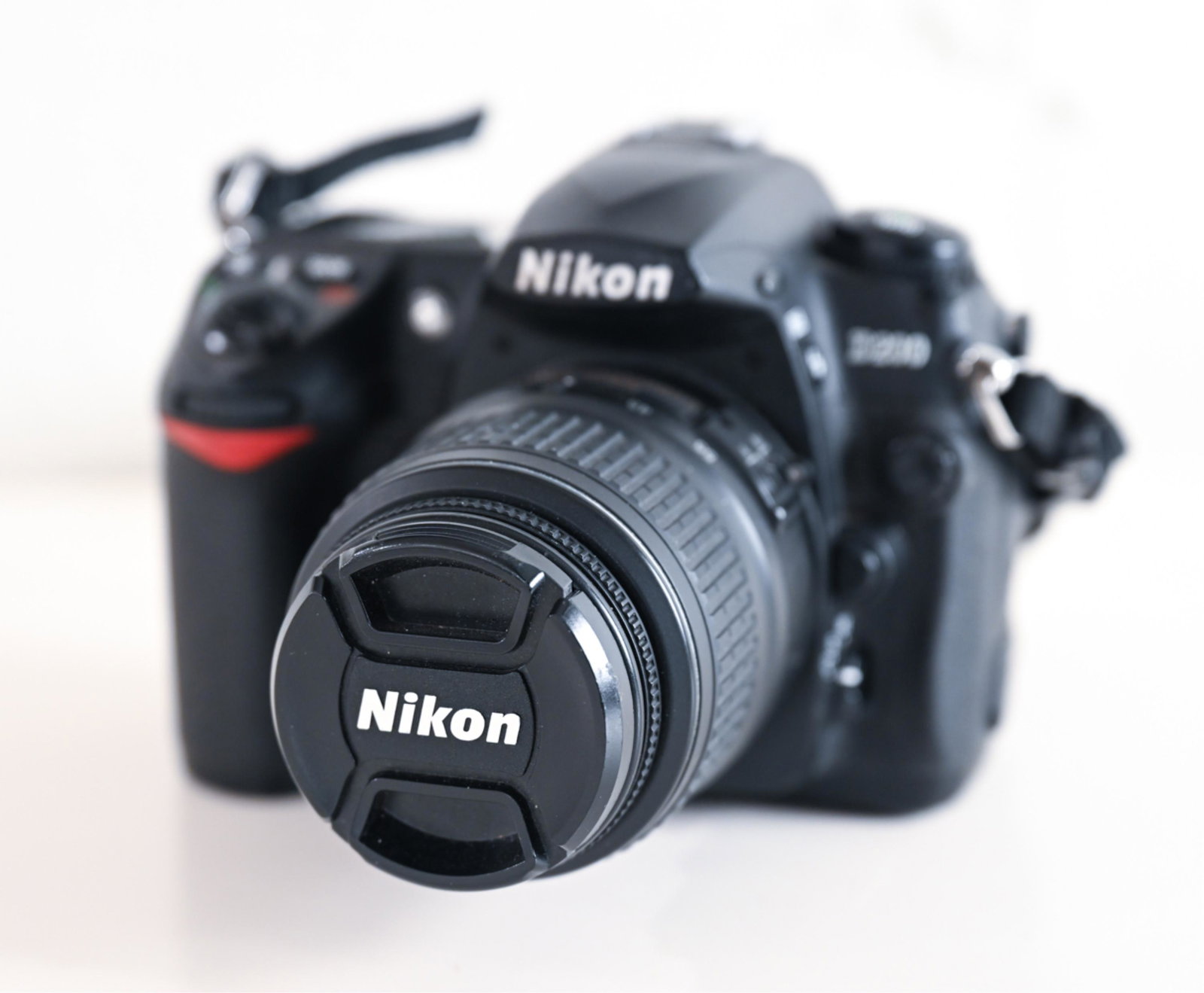 NIKON D200 W 18-55mm LENS: Dimensions: H 5" x W 6" x D 5.5" Condition: Showing signs of wear consistent with age and use. Turns on but not tested.