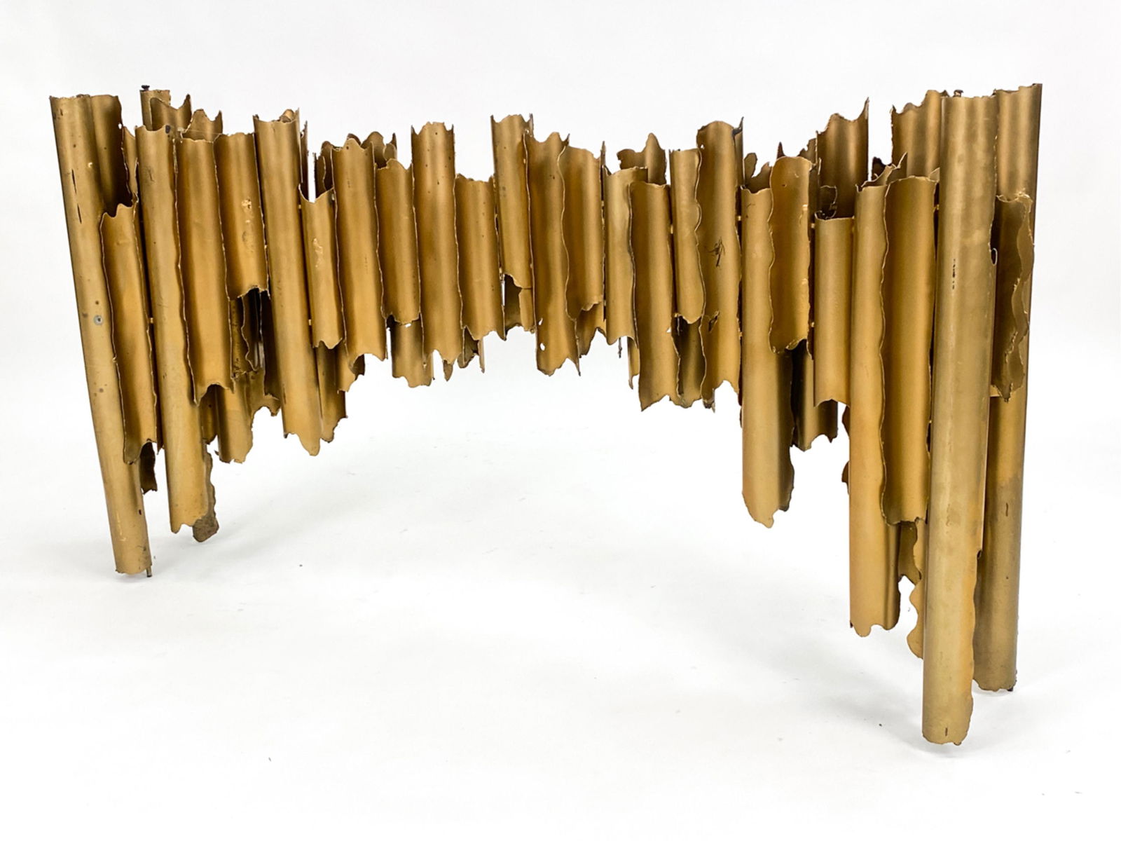 BRUTALIST TORCH CUT METAL CONSOLE TABLE: Mid-Century torch cut metal brutalist console in the manner of Tom Greene. Glass top. Apparently unsigned. Dimensions: H 31" x W 57.5" x D 11" Condition: Rich patina. Minor surface scratches and wear