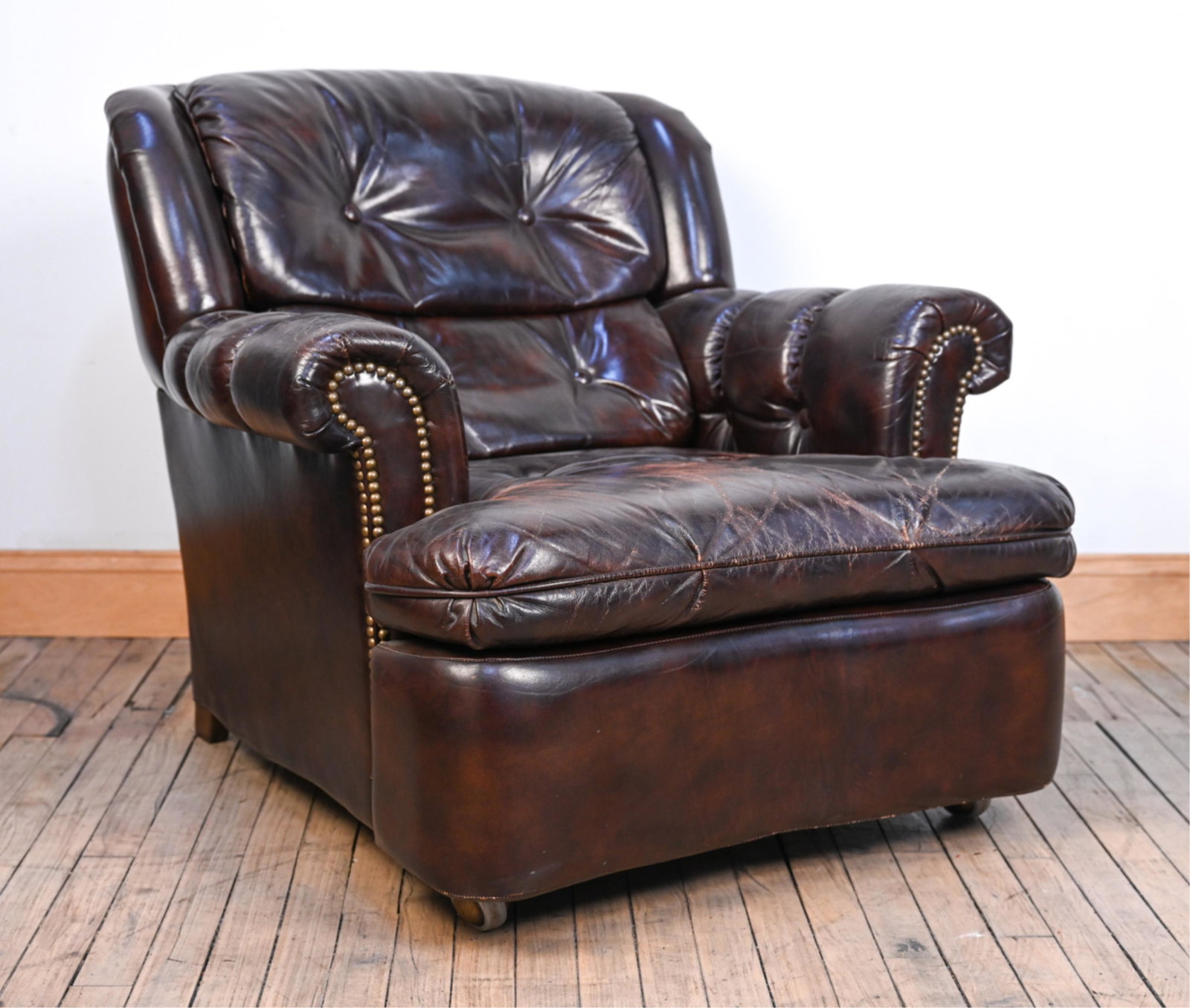 VINTAGE SCHAFER BROS. BONDED LEATHER RECLINER: Dimensions: (Upright) H 31.5" x W 36" x D 39" x SH 16"; when reclining, depth measures 56" Condition: Patina and minor cracking to leather; some flattening to cushions. Wear consistent with age and us