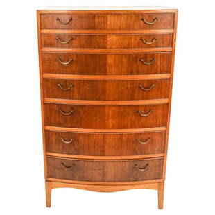 OLE WANSCHER FOR AJ IVERSEN CHEST OF DRAWERS: This rare, handsome tall seven-drawer chest was designed by Ole Wanscher for renowned Danish cabinetmaker AJ Iversen in the 1940's. Featuring mahogany wood with a bowed front and brass bale handles.