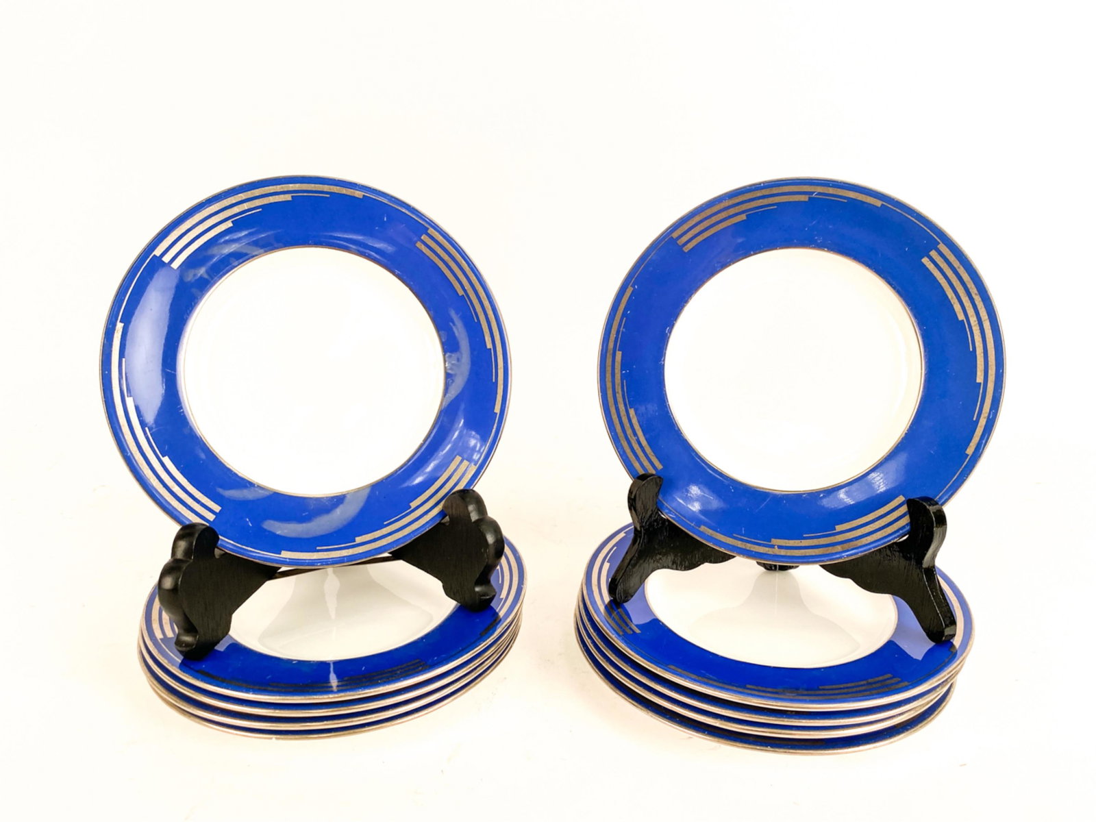 (10) MINTONS ART DECO SAUCERS: Appears to be design in platinum and blue. Marked underneath. Dimensions: Dia. 6.5" Condition: One with extensive crack. Others with wear. Some misfiring in the blue.