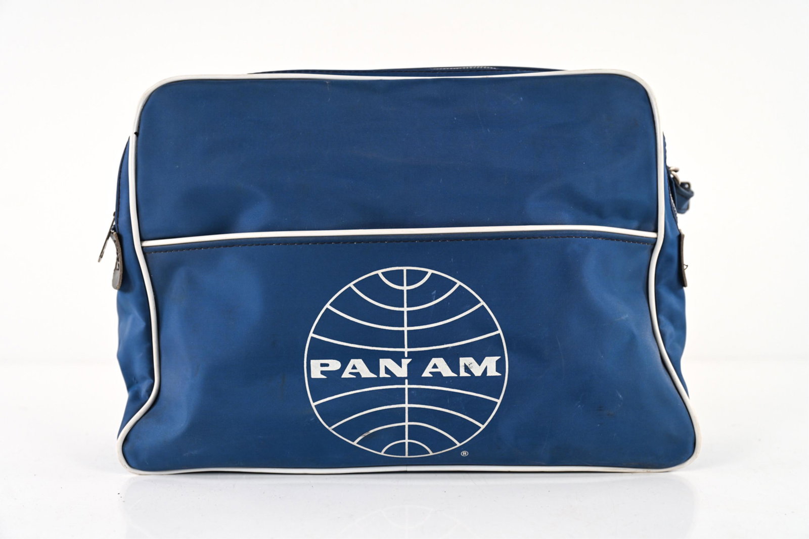 C. 1960'S PAN AM AIRWAYS NYLON STEWARDESS BAG: Vintage c. 1960's Travelite Nylon stewardess bag with Pan Am logo, adjustable strap. Dimensions: H 10.25" x W 16" x D 5.25", (Strap drop, longest) 7.5" Condition: Signs of age and use including some s