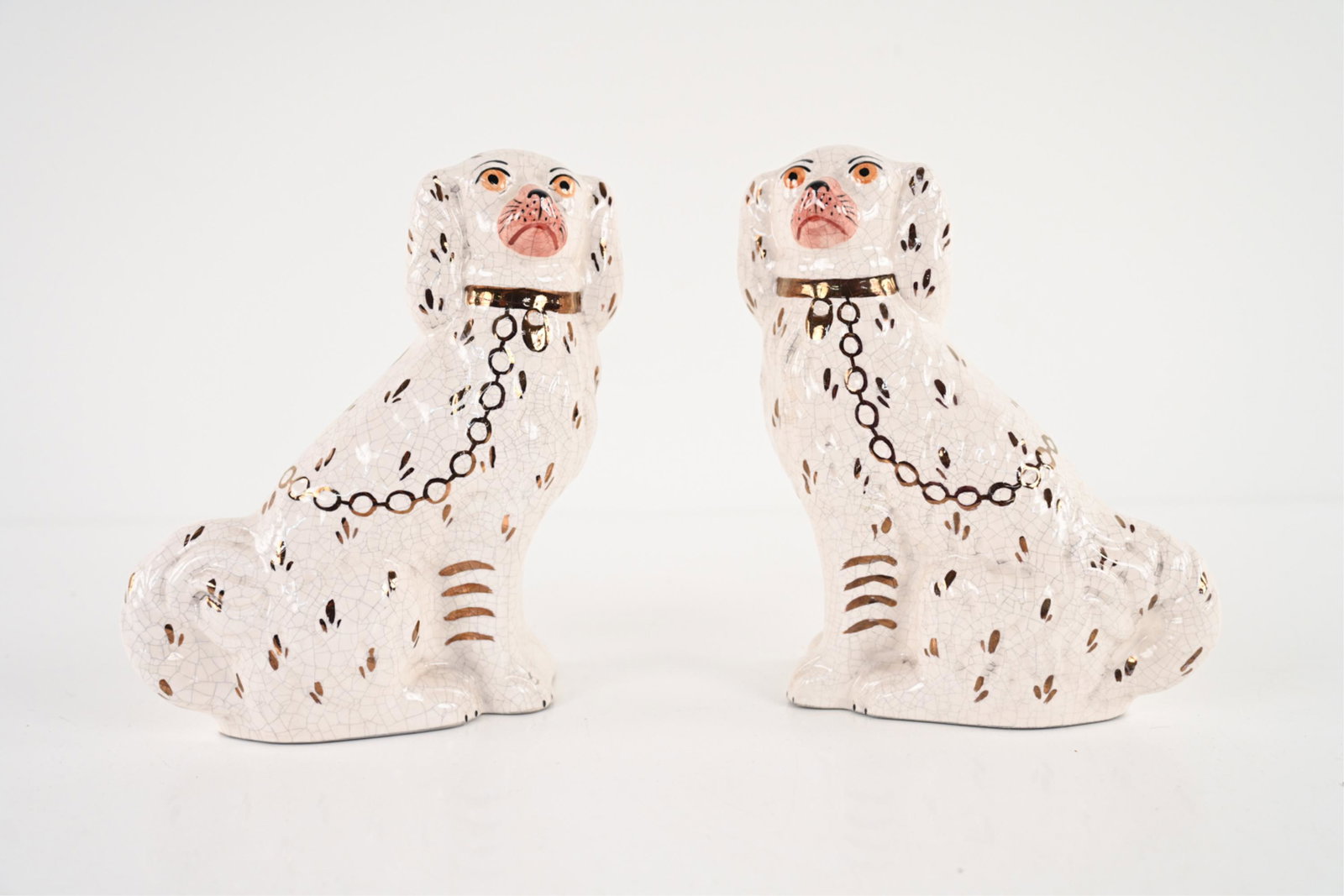 PAIR OF CONTEMPORARY STAFFORDSHIRE DOGS: Both marked Staffordshire Ware Kent, Made in England. Paint decorated over crackle glaze. Dimensions: H 9.5" x W 7" x D 3" Condition: No issues to note.