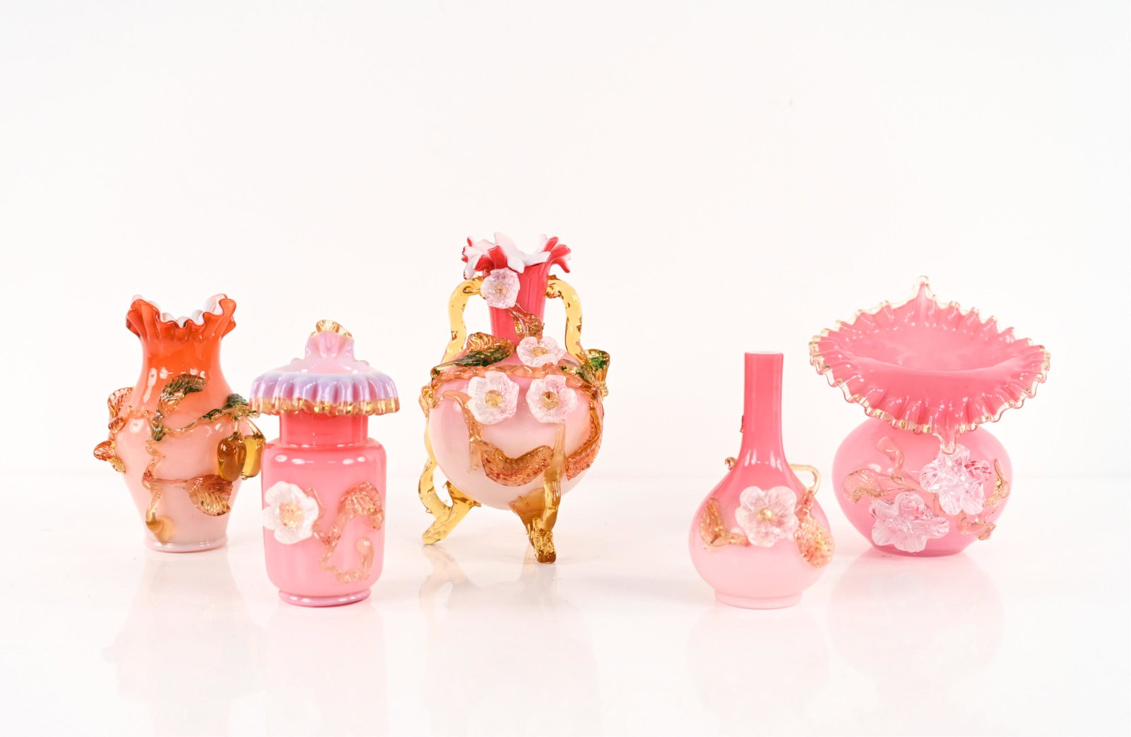 (5) MANNER OF STEVENS & WILLIAMS ART GLASS VASES: Ruffled cased glass vases with lampwork applique in motifs of flowers, fruit, and vines. Apparently unsigned. Dimensions: (Tallest) H 9" x Dia. 5.25" Condition: A few rough edges to applique and feet;