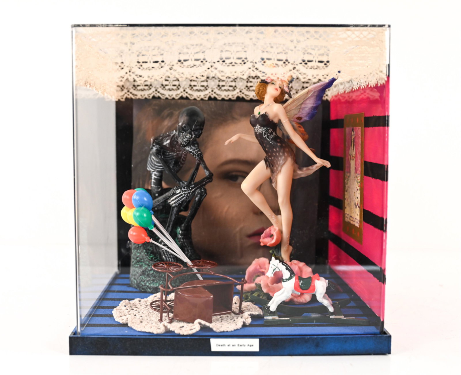 ROLAND ROBERGE (1945-2020) DIORAMA: Found-object sculpture in plexiglass diorama. Titled "Death at an Early Age". Dimensions: H 12.25" x W 12.25" x D 12.25" Condition: Wear consistent with age. Elements may be detached, broken, or missi