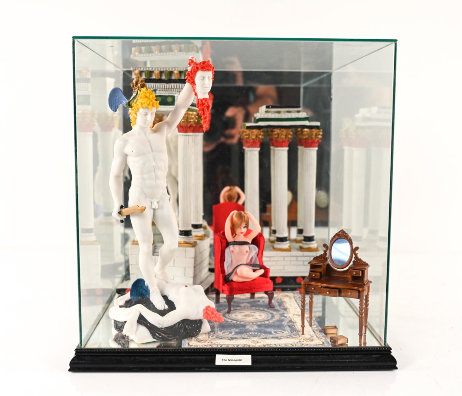 ROLAND ROBERGE (1945-2020) DIORAMA: Found-object sculpture in glass diorama. Titled "The Mysoginist". Dimensions: H 15" x W 15" x D 15.25" Condition: Wear consistent with age. Elements may be detached, broken, or missing. A few nicks to
