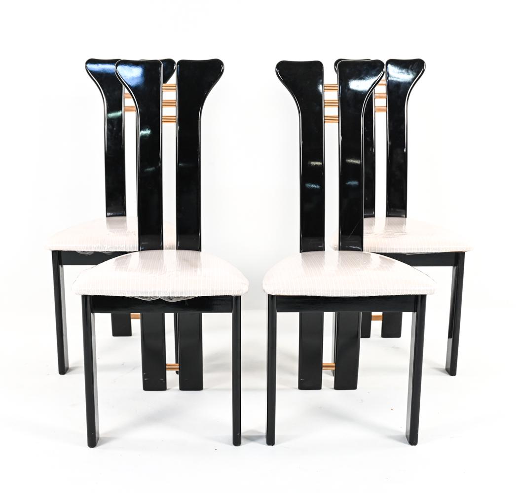 (4) ATTR. PIERRE CARDIN ROCHE BOBOIS DINING CHAIRS: Set of (4) sculptural Postmodern dining chairs in black lacquer with inlaid striped slats. Design attributed to Pierre Cardin for Roche Bobois, c. 1980's. Dimensions: H 42" x W 19" x D 23" x SH 19" Co