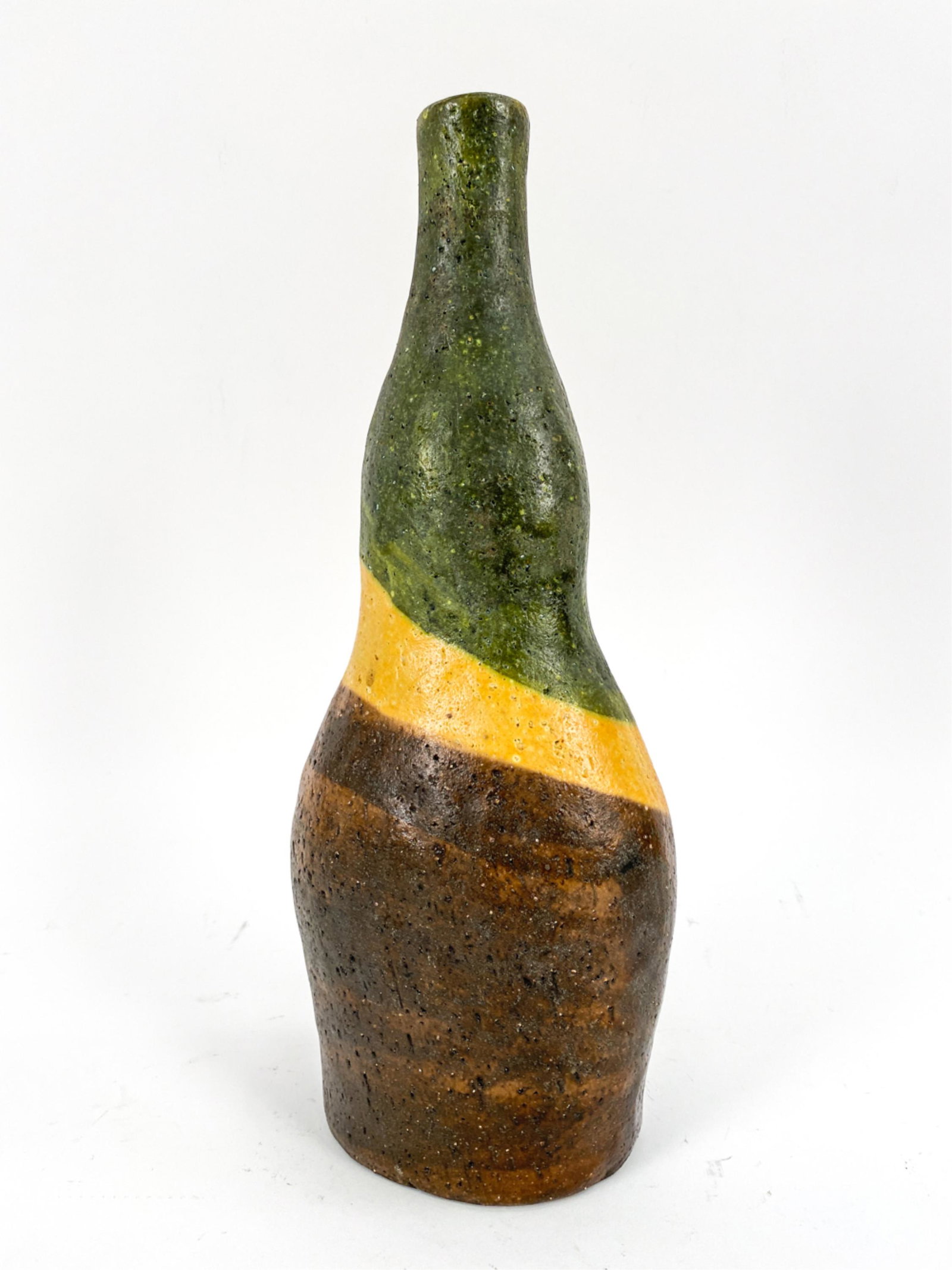 MARCELLO FANTONI FOR RAYMOR SCULPTURAL TALL VASE: Sculptural form. Green, yellow, and brown glaze. Signed Fantoni, Italy, for Raymor underneath. Dimensions: H 12.75" x W 5" x D 3.5" Condition: Chip to bottom edge.