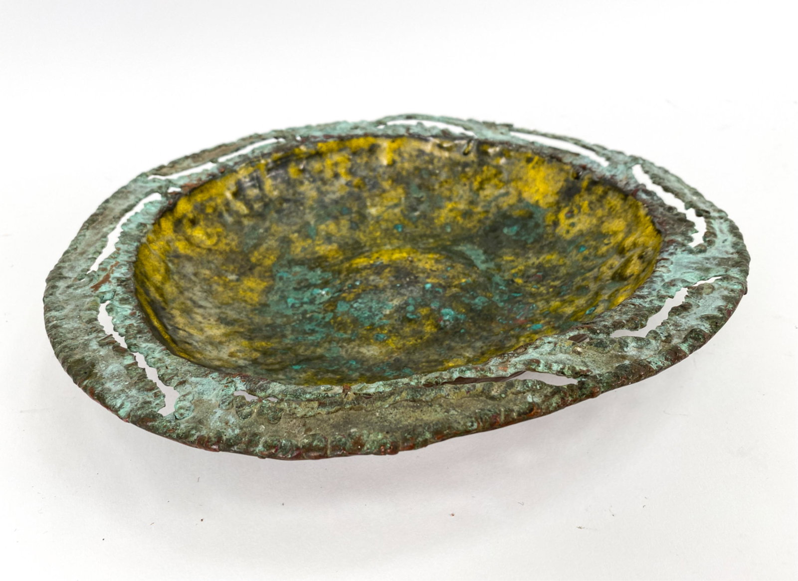 MARCELLO FANTONI ENAMELED TORCH CUT CHARGER: Signed underneath: Fantoni, Firenze, Raymor. Torch cut and patinated metal with enameled interior. Dimensions: H 2" x Dia. 12" Condition: Intentionally brutalist surface.
