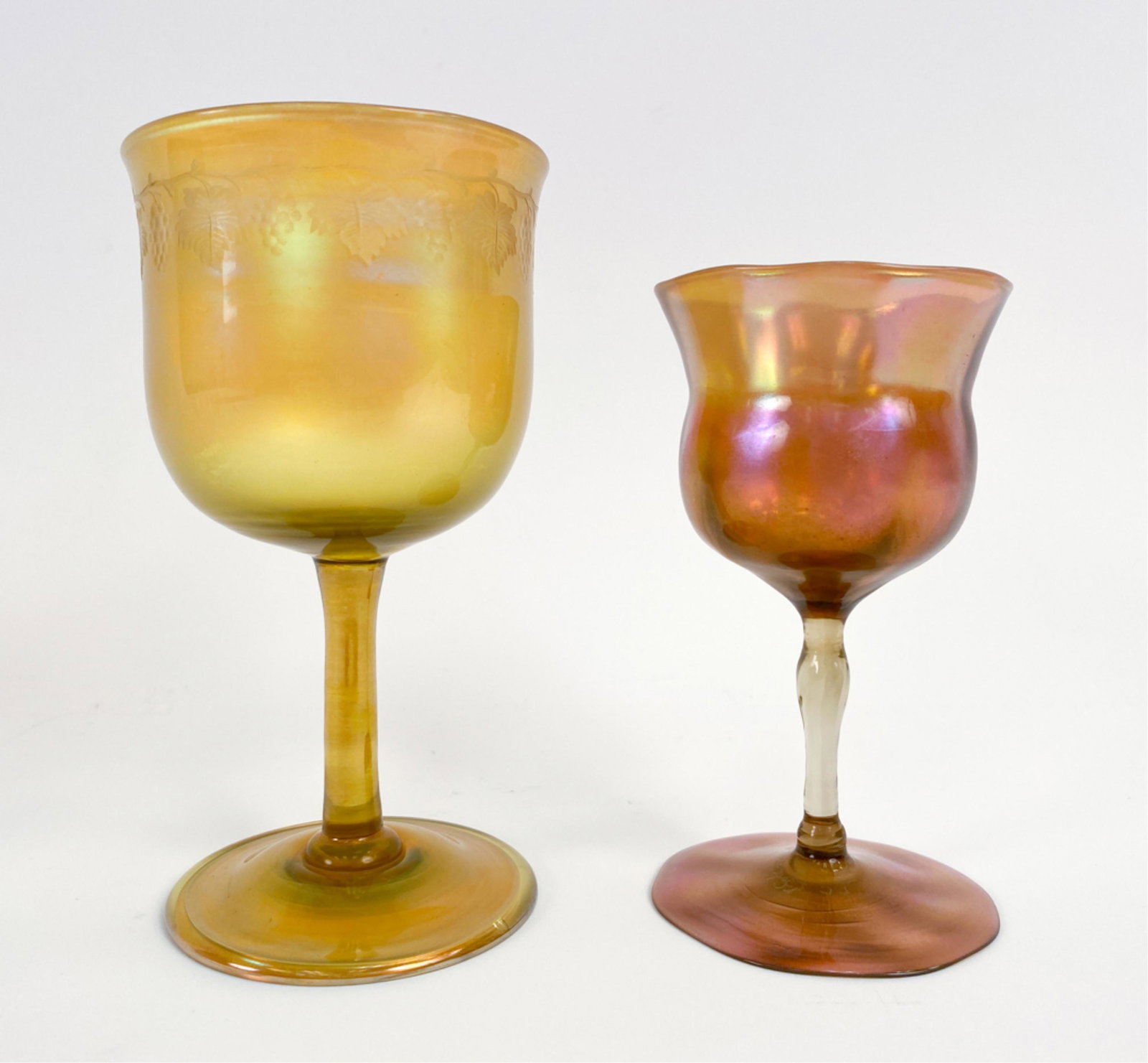 (2) LOUIS COMFORT TIFFANY FAVRILE GLASS GOBLETS: Both signed underneath. Dimensions: (Larger) H 6" x Dia. 3.25" Condition: Very minor handling wear.