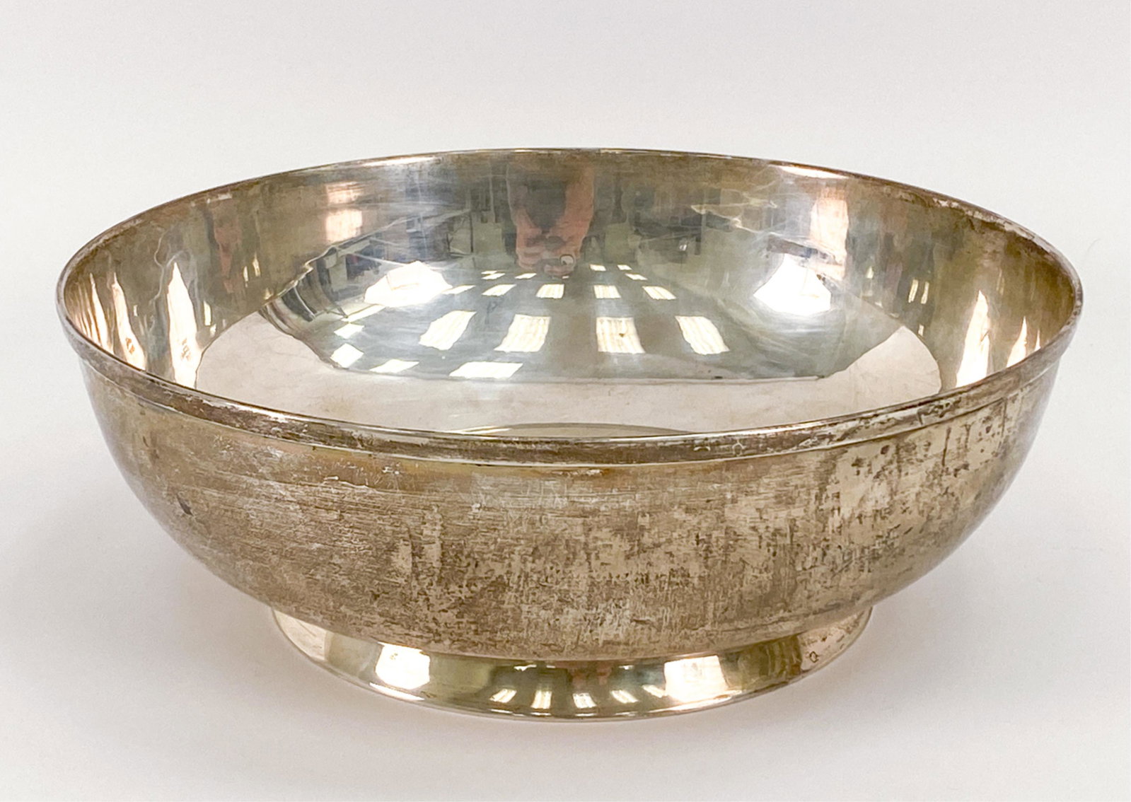 CARTIER STERLING SILVER LARGE BOWL: Marked underneath: Cartier, sterling. Dimensions: H 3.5" x Dia. 10.25" Weight: 27.985 ozt Condition: Light tarnish and surface scratches.
