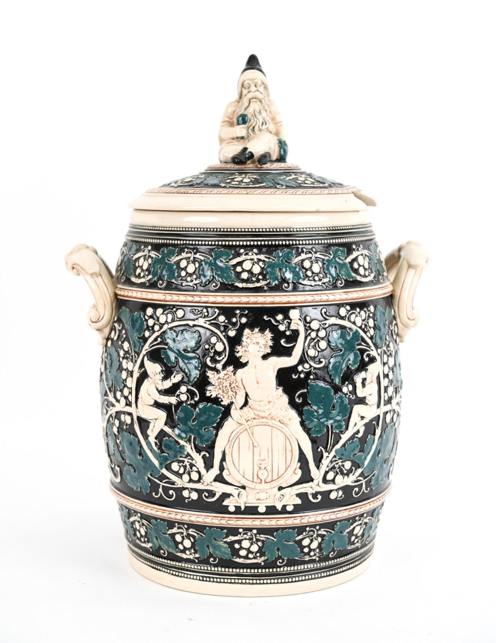 19TH CENTURY GERMAN STONEWARE CROCK: Bacchus and wine motif, apparently unmarked. Dimensions: (With lid) H 19" x W 13" x D 11" Condition: Repaired break to hat on finial; chips and small losses to one handle, a few tiny hairlines. Small 