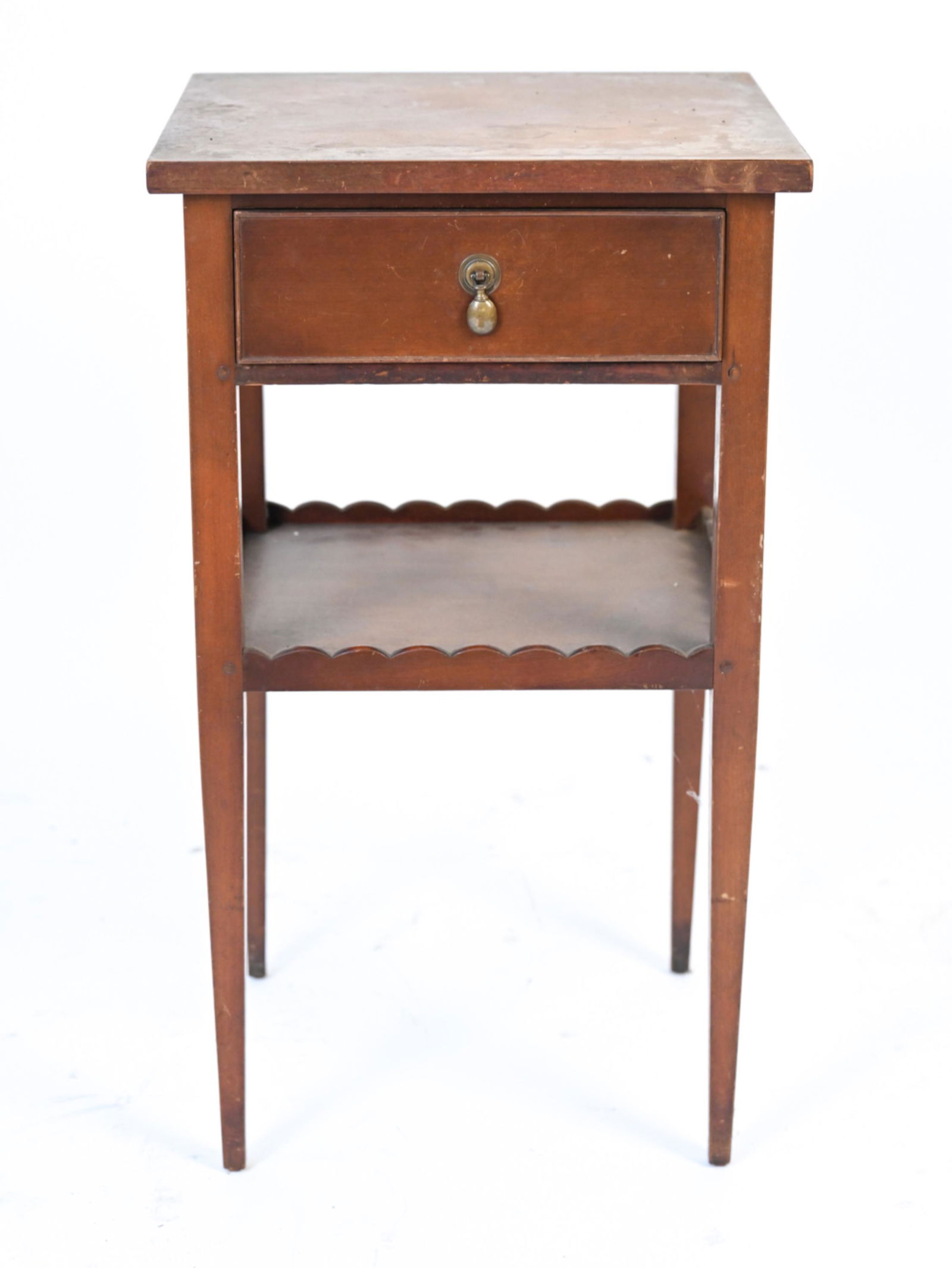 MID-CENTURY ONEIDACRAFT SIDE TABLE, AS-IS: With one dovetailed drawer and scalloped lower gallery. Marked Oneidacraft with plaque and heatstamp on drawer. Dimensions: H 29.25" x W 16.75" x D 15" Condition: As-is; in need of refinishing. Top wi