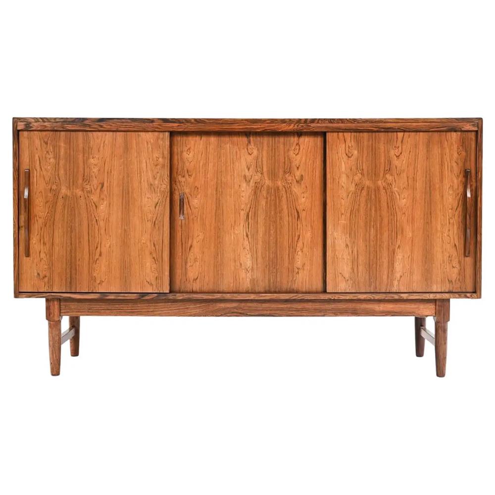 SORO DANISH MID-CENTURY ROSEWOOD SIDEBOARD: A stunning Danish mid-century tall sideboard by Soro Mobelfabrick in handsome rosewood veneer. Interior is fitted with ample shelving. On sleek tapered legs. This versatile piece would be eye-catching