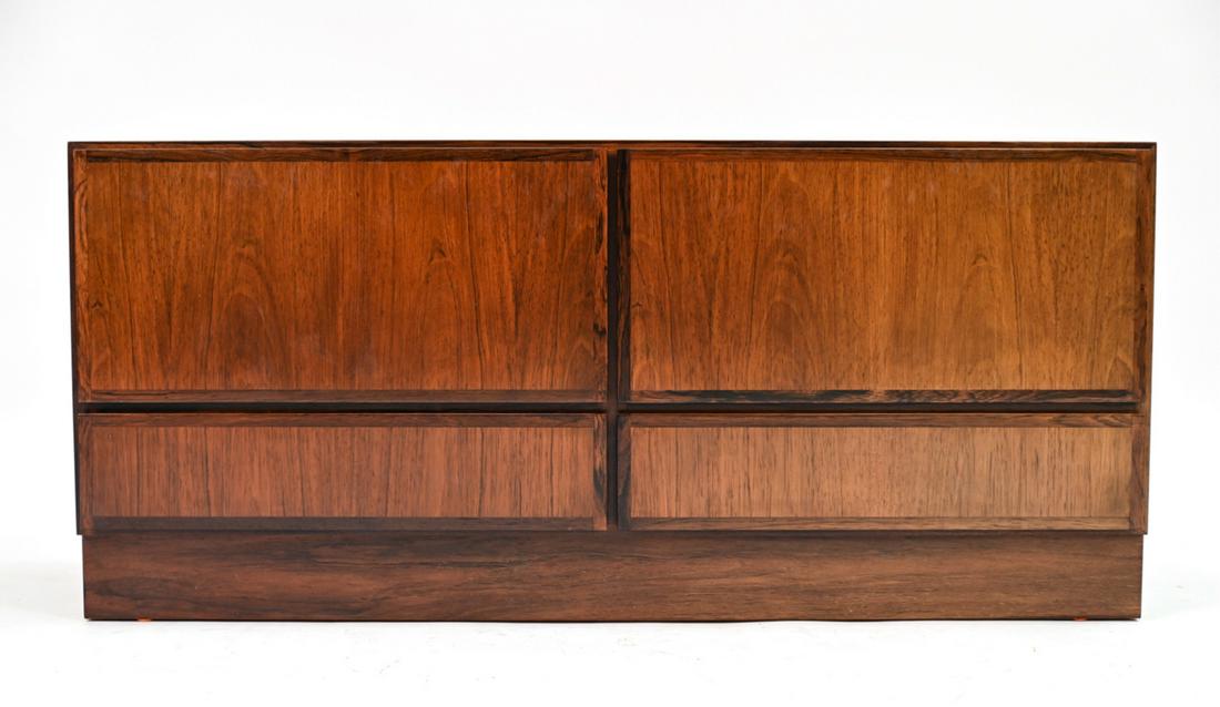 OMANN JUN. MODEL NR. 2 ROSEWOOD SIDEBOARD: With label verso "Omann Jun. A/S, Model Nr. 2." Danish mid-century sideboard/media cabinet. c. 1960's. Dimensions: H 21.5" x W 47.25" x D 17" Condition: Lacking legs. Holes cut to back for media use.