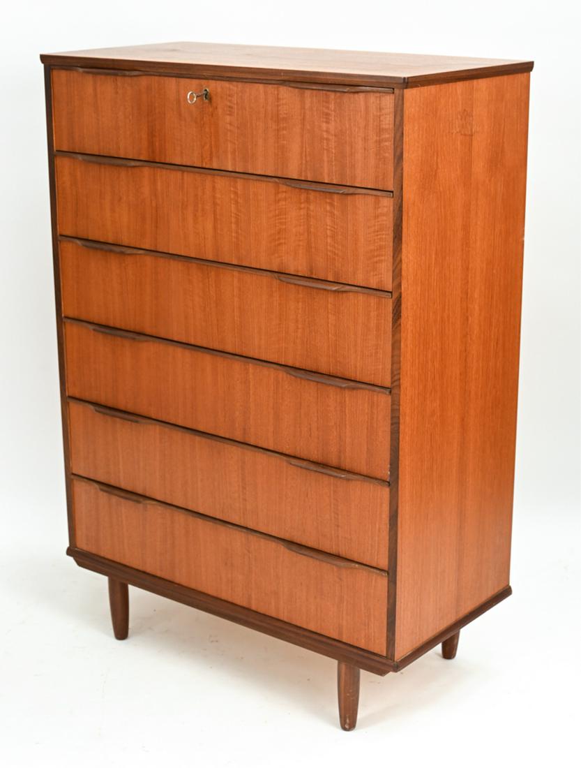 DANISH MID-CENTURY TEAK CHEST ATTR. WESTERGAARD: Tall Danish mid-century chest of drawers in teak with sculptural drawer pulls, uppermost drawer with lock (key present), and tapered legs. No apparent labels. Dovetailed drawer joints. Dimensions: H 4