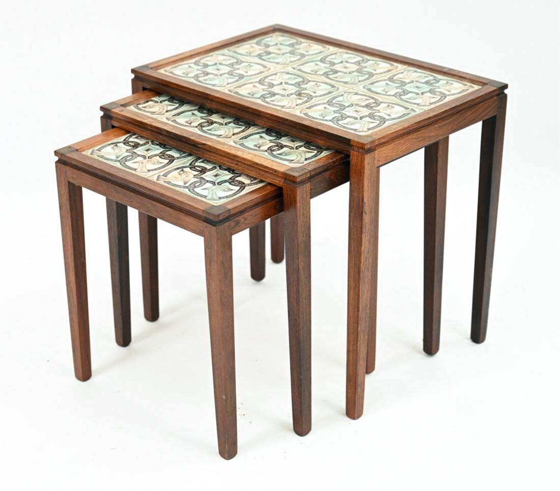 (3) DANISH ROSEWOOD & TILE TOP NESTING TABLES: (3) Danish mid-century rosewood nesting tables in the manner of Haslev with Royal Copenhagen-style bird and interlace motif tile tops. No apparent markings. Dimensions: (Largest) H 19" x W 20.25" x D