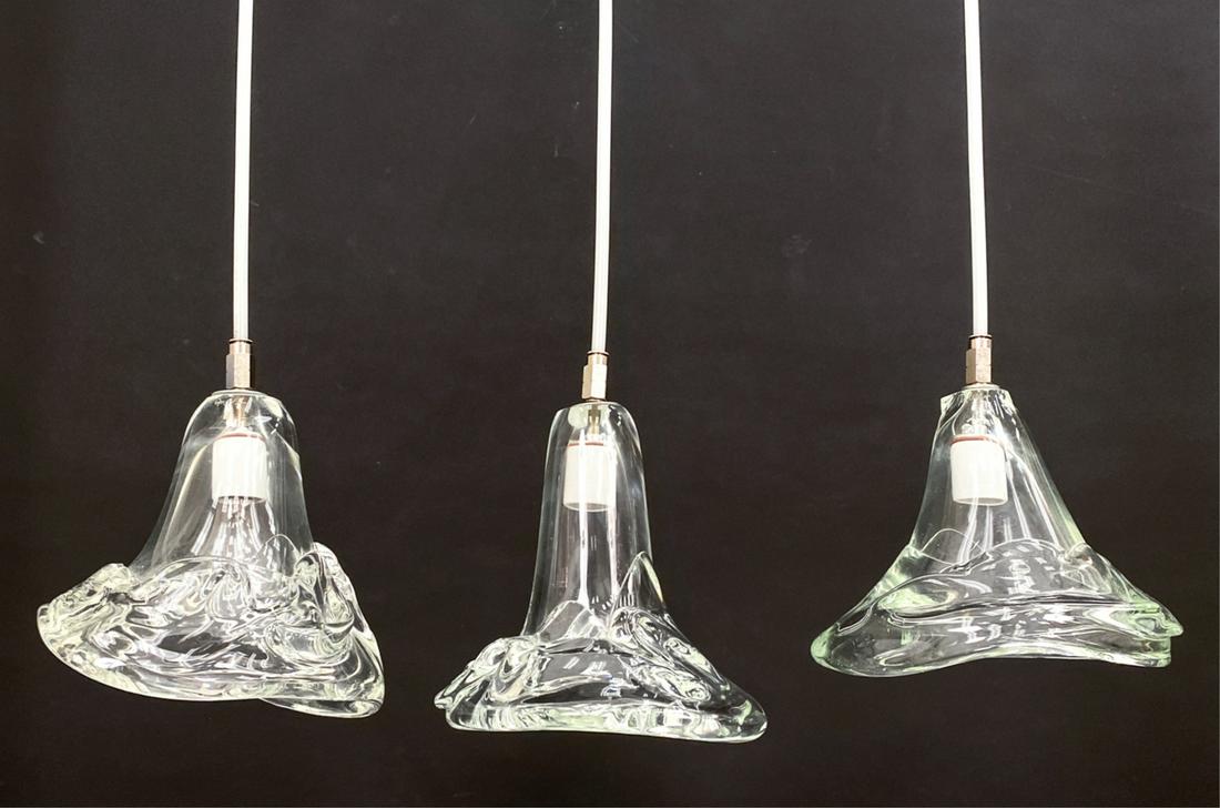 (3) MODERN BLOWN CRYSTAL PENDANT LAMPS: Contemporary. Abstracted designs, each one signed. Dimensions: (Glass) H 10" x W 10" x D 9" Condition: Some bubbles and inclusions in the glass. No noticeable damages. Functional when taken down.