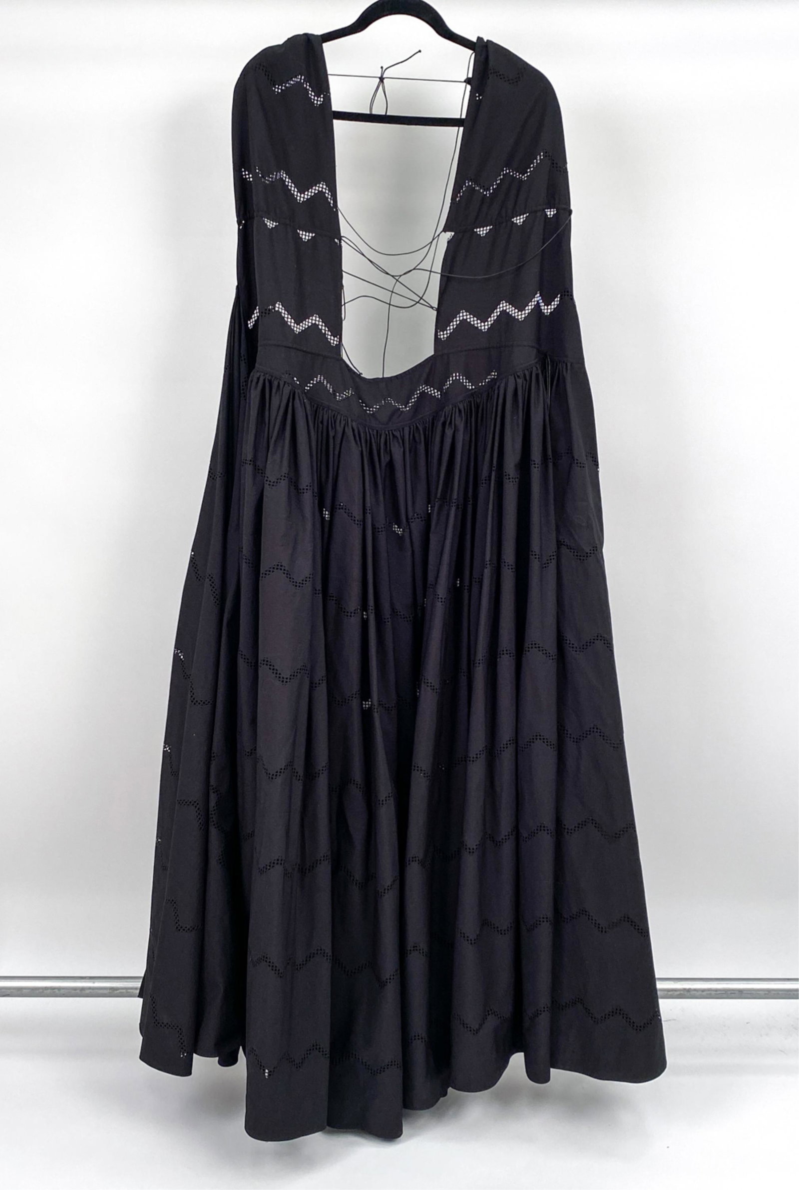 ALAIA LASER-CUT POPLIN FULL TUNIC DRESS: Genuine Alaia resort coverup or tunic dress in black cotton poplin with laser-cut zig zag detail, featuring an open lace-up back, high neck with plunging split, and full flared open-front skirt. Size 
