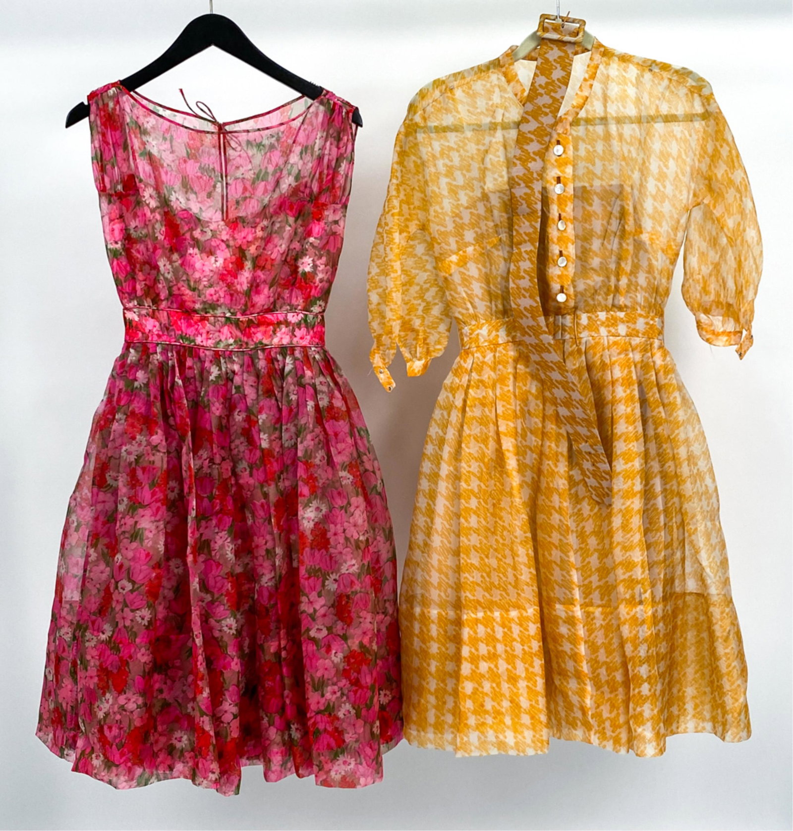 (2) 1960'S-1970'S MOLLIE PARNIS ORGANZA DRESSES: (2) Fabulous dresses by Mollie Parnis, in sheer printed organza with silk and taffeta linings. Both approx. waist size 25". Condition: In very good vintage condition overall; a few tiny spots of soili
