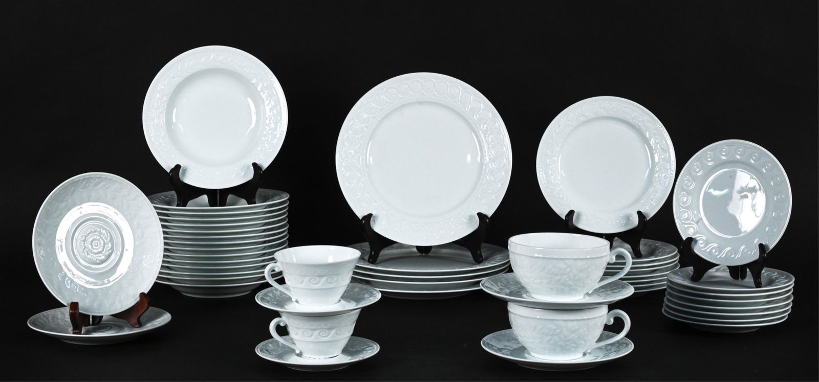 BERNARDAUD LIMOGES LOUVRE PORCELAIN DINNERWARE: Embossed white porcelain "Louvre" dinnnerware by Bernardaud Limoges, including: (5) dinner plates, (8) salad plates, (8) bread & butter plates, (15) rim soup bowls, (2) jumbo flat cups with (4) large