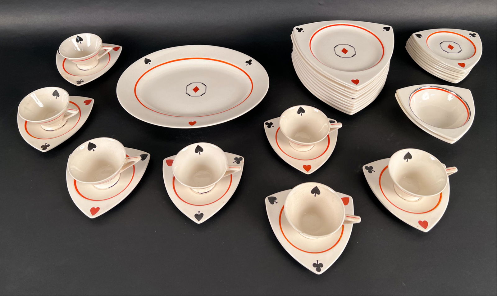 RARE 1940'S SALEM TRICORNE PLAYING CARD SERVICE: Rare Streamline Art Deco luncheon or dessert service in the Tricorne shape by Salem, decorated with playing card suit motifs. Includes: (11) luncheon plates, (8) bread & butter plates, (7) footed teac