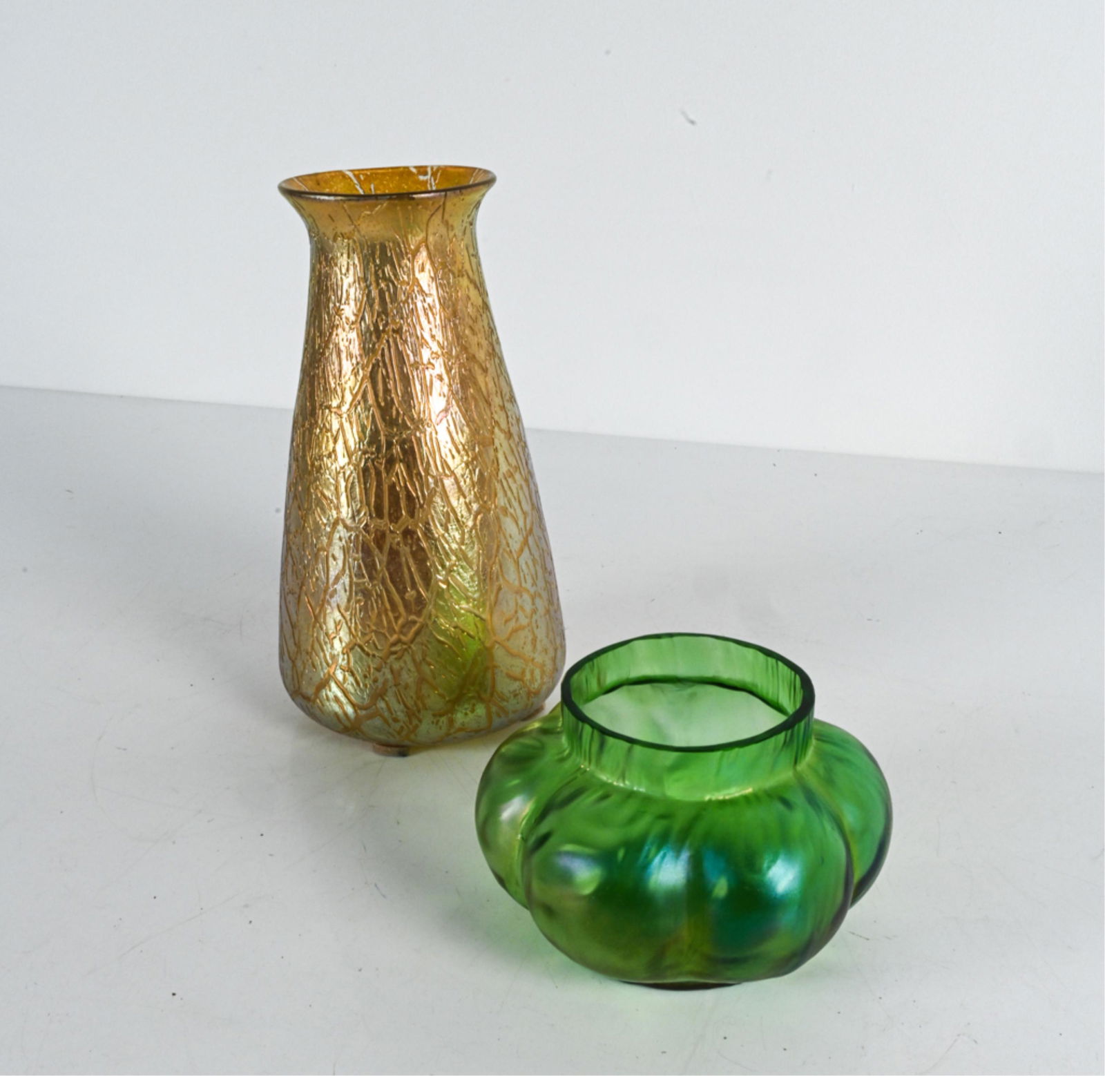 (2) LOETZ-STYLE IRIDESCENT ART GLASS VASES: Contemporary. Apparently unsigned. Dimensions: (Taller) H 11" x Dia. 6" Condition: Green with few flea bites to rim.