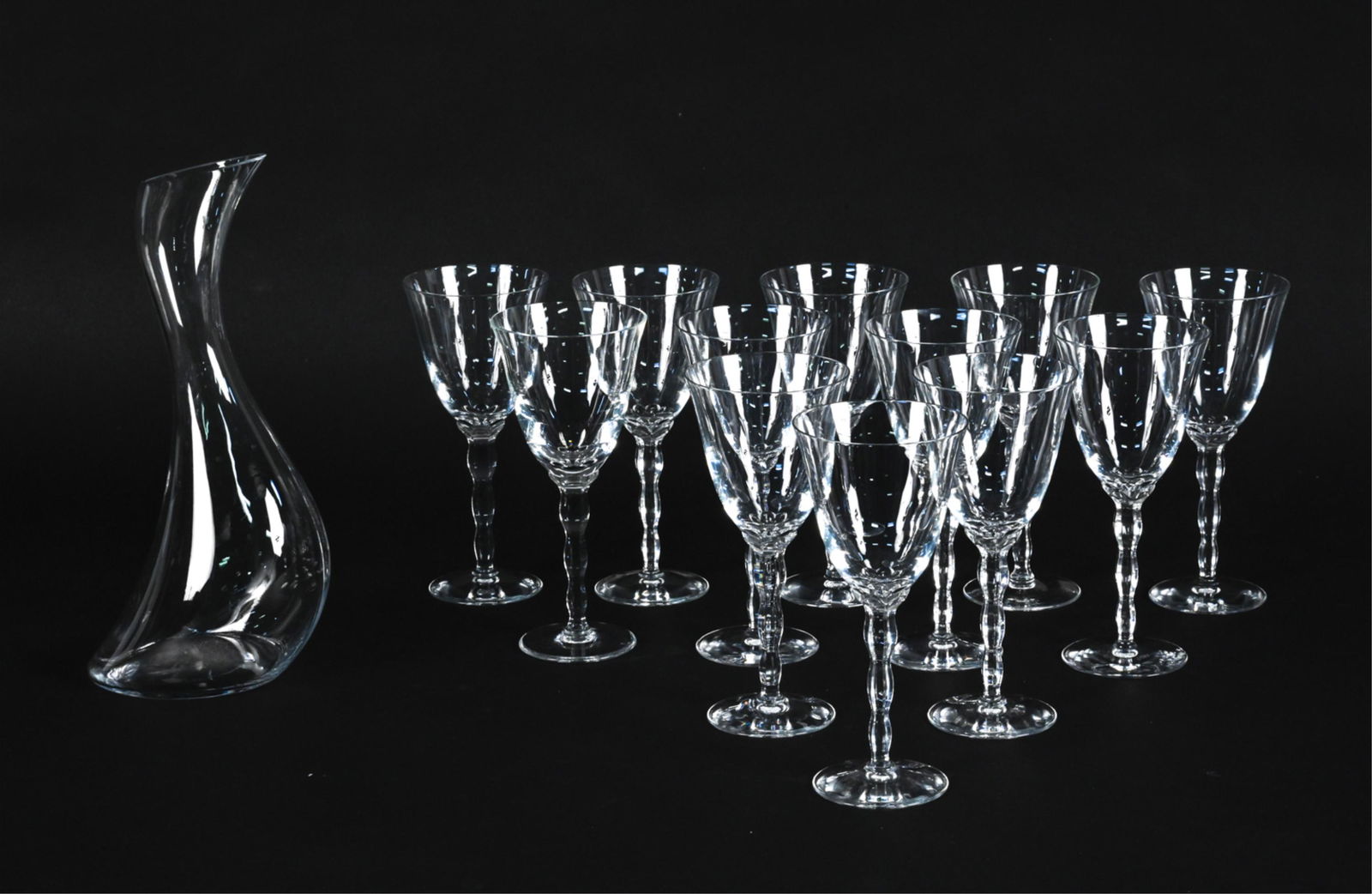 CHRISTOFLE CRYSTAL GOBLETS & GEORG JENSEN CARAFE: Georg Jensen "Cobra" glass carafe, with (12) red wine goblets from the "Kawali" pattern by Christofle. All pieces signed underneath. Dimensions: (Carafe) H 12" x W 5.5" x D 4.25" Condition: No issues