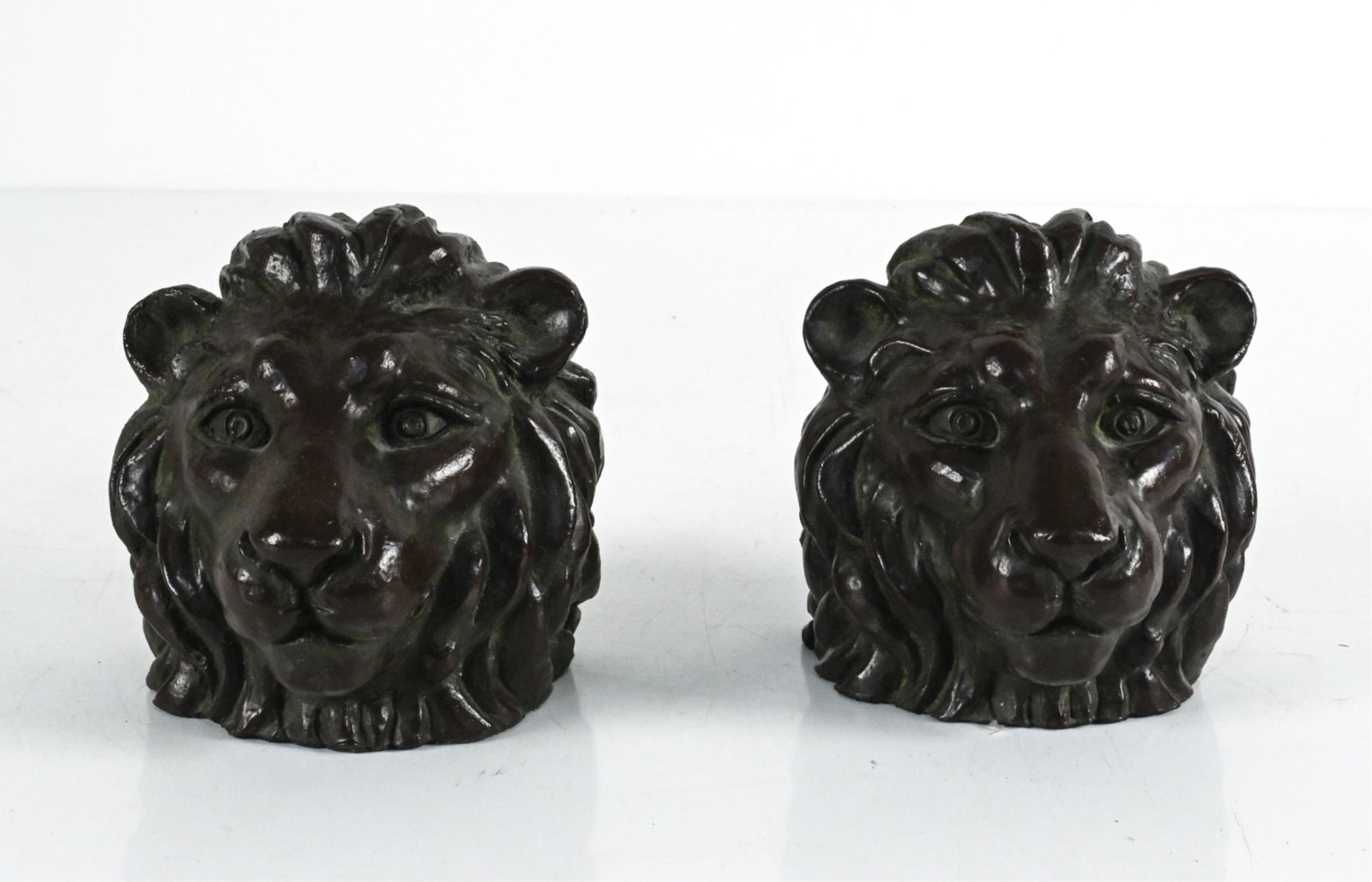 PAIR OF BRONZED CAST METAL LION HEAD BOOKENDS (1 of 9)
