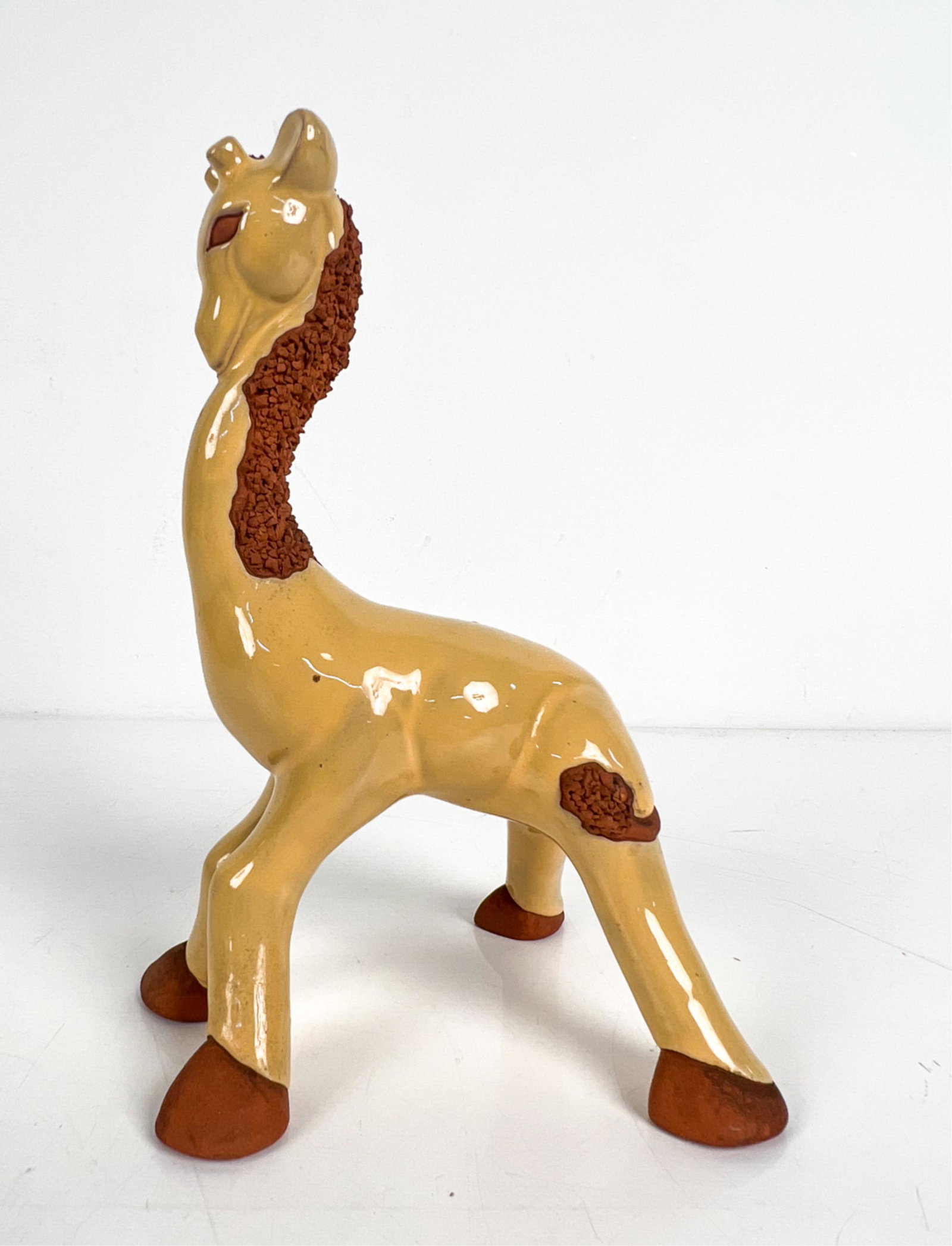 MID-CENTURY STUDIO POTTERY GIRAFFE, SIGNED: Apparently signed "by Ray" or "by Kay" and titled "Archibald" under left front hoof. Dimensions: H 9" x W 5" x D 5.5" Condition: No issues to note.