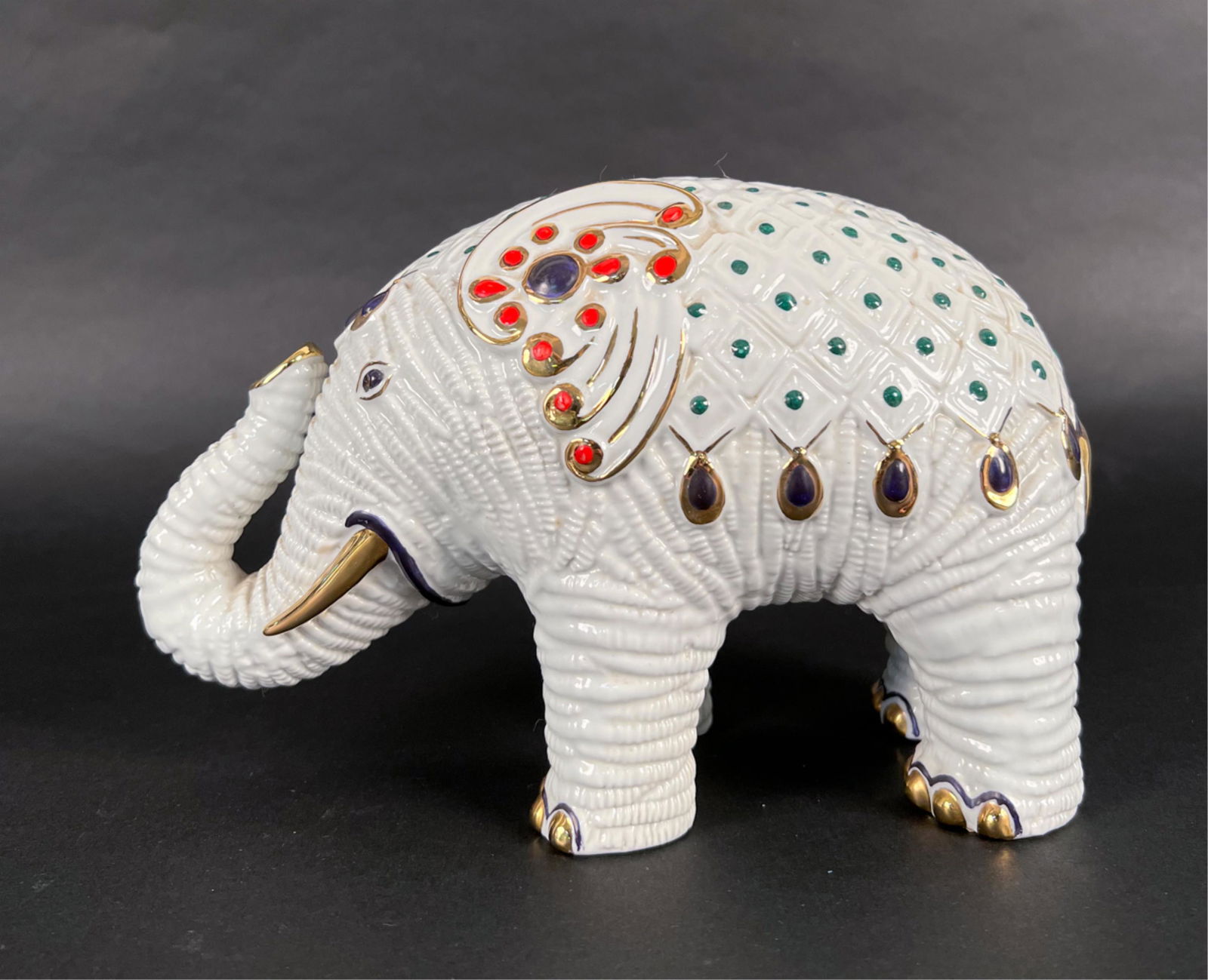 BUCCELLATI SAN MARCO PORCELAIN ELEPHANT: Labeled underneath. Dimensions: H 6" x W 9" x D 4" Condition: A few light rubs to gilding.