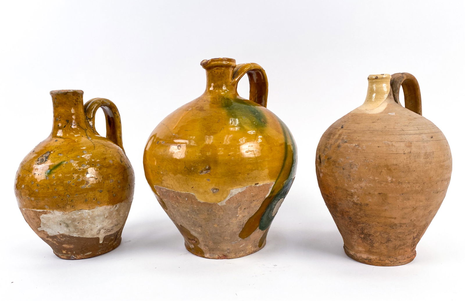 GROUP OF FRENCH ANTIQUE “PLONGEONS" BOTTLES: (3) antique French "plongeons" (bottles, dervied from French verb "plonger"-to dive. This pottery was used for plunging the vessel into tight water sources. 18th and 19th century forms. The 19th centu