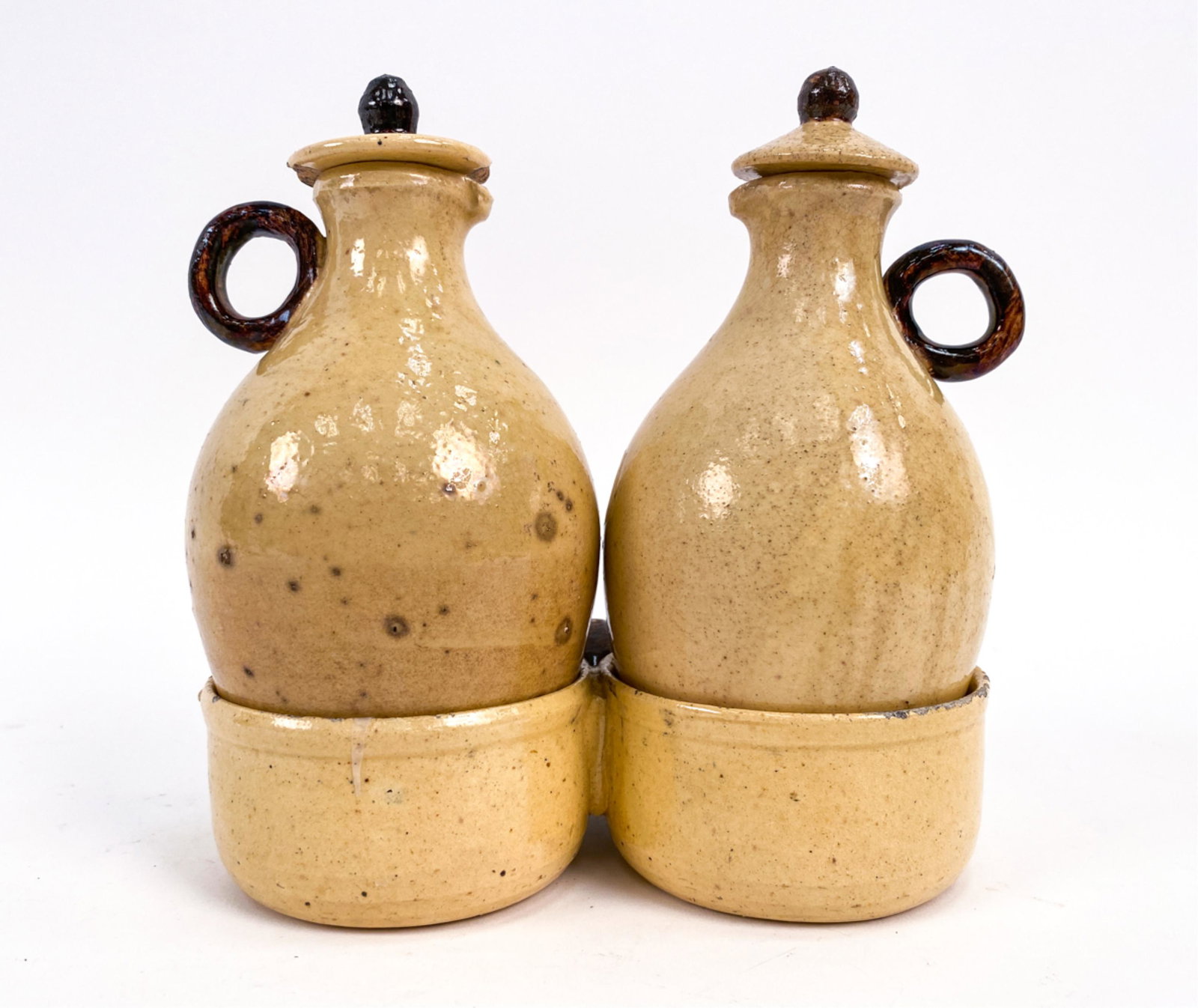 19TH C. PROVENCAL VALLAURIS SALIERE OIL/VINEGAR: Antique oil and vinegar set with lids and holder. Dimensions: (Overall) H 6.75" x W 6.25" x D 4" Condition: Some crazing to glaze. Few small chips and losses.
