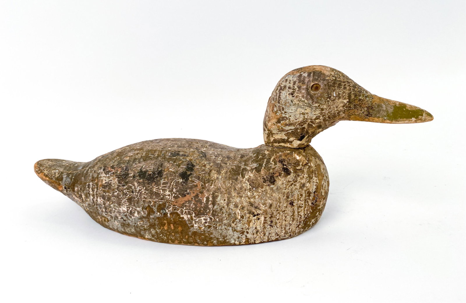 ANTIQUE AMERICANA WOODEN DUCK DECOY: New England. Dimensions: H 6" x W 16.25" x D 5" Condition: Surface losses, stress cracks, and antique wear throughout.