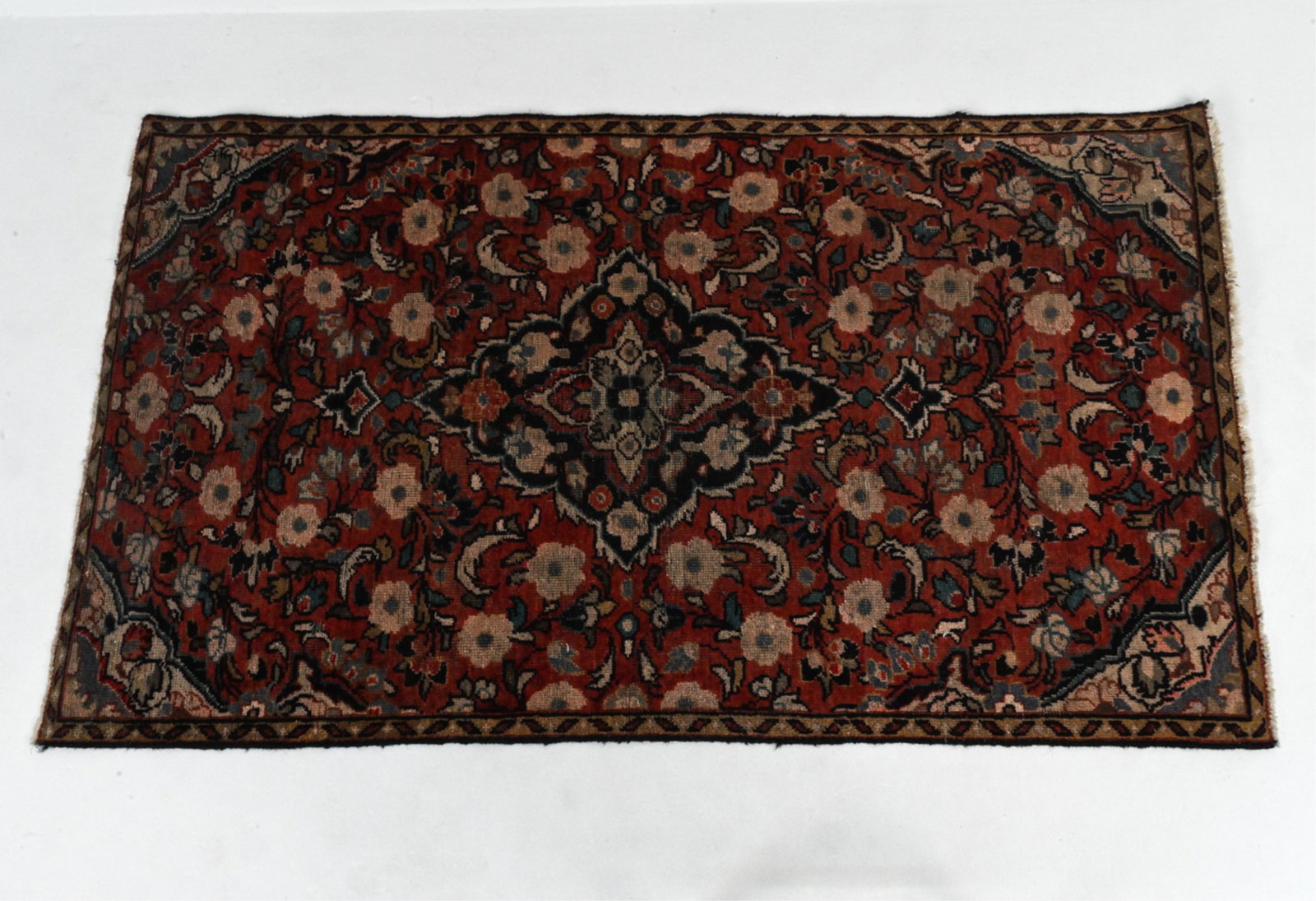 IRANIAN HAND-KNOTTED THROW RUG: Dimensions: L 72" x W 42.25" Condition: Cleaning recommended; surface dirt and dust; some sun fading and light rubbing to pile; fringe cut, some fraying to binding at edges.