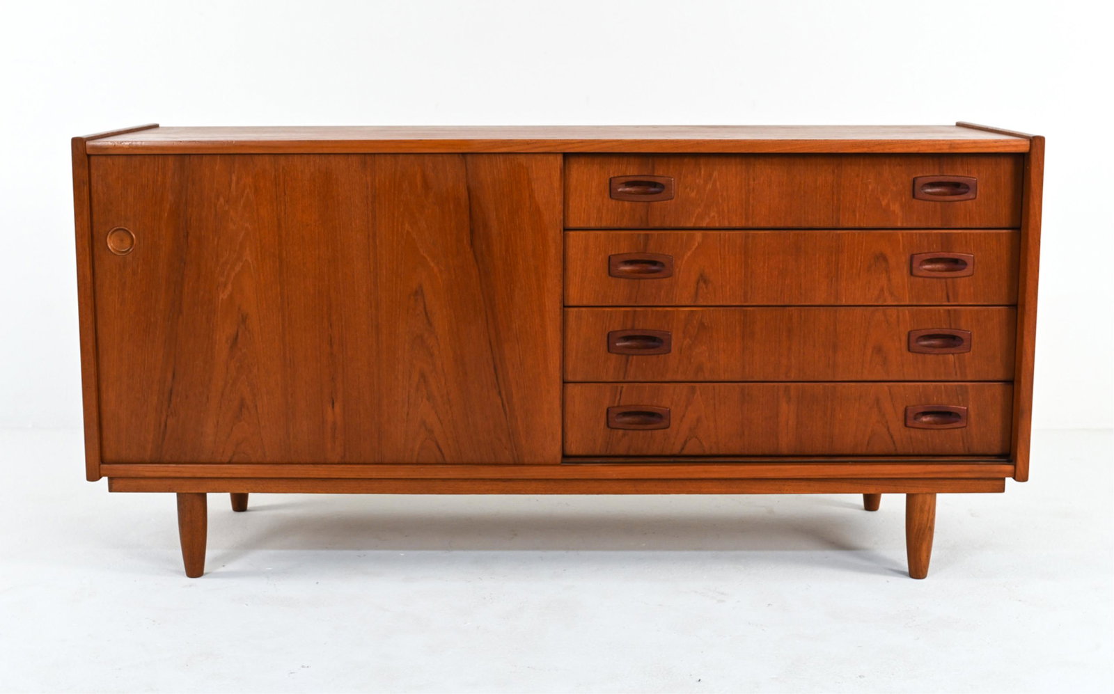 DANISH TEAK SIDEBOARD CREDENZA, C. 1960'S: Dimensions: H 27.5" x W 56.75" x D 17.25" Condition: Teak oiled. A few small nicks and scuffs; a couple spots of soiling to drawer interiors; overall light wear consistent with age and use. A075