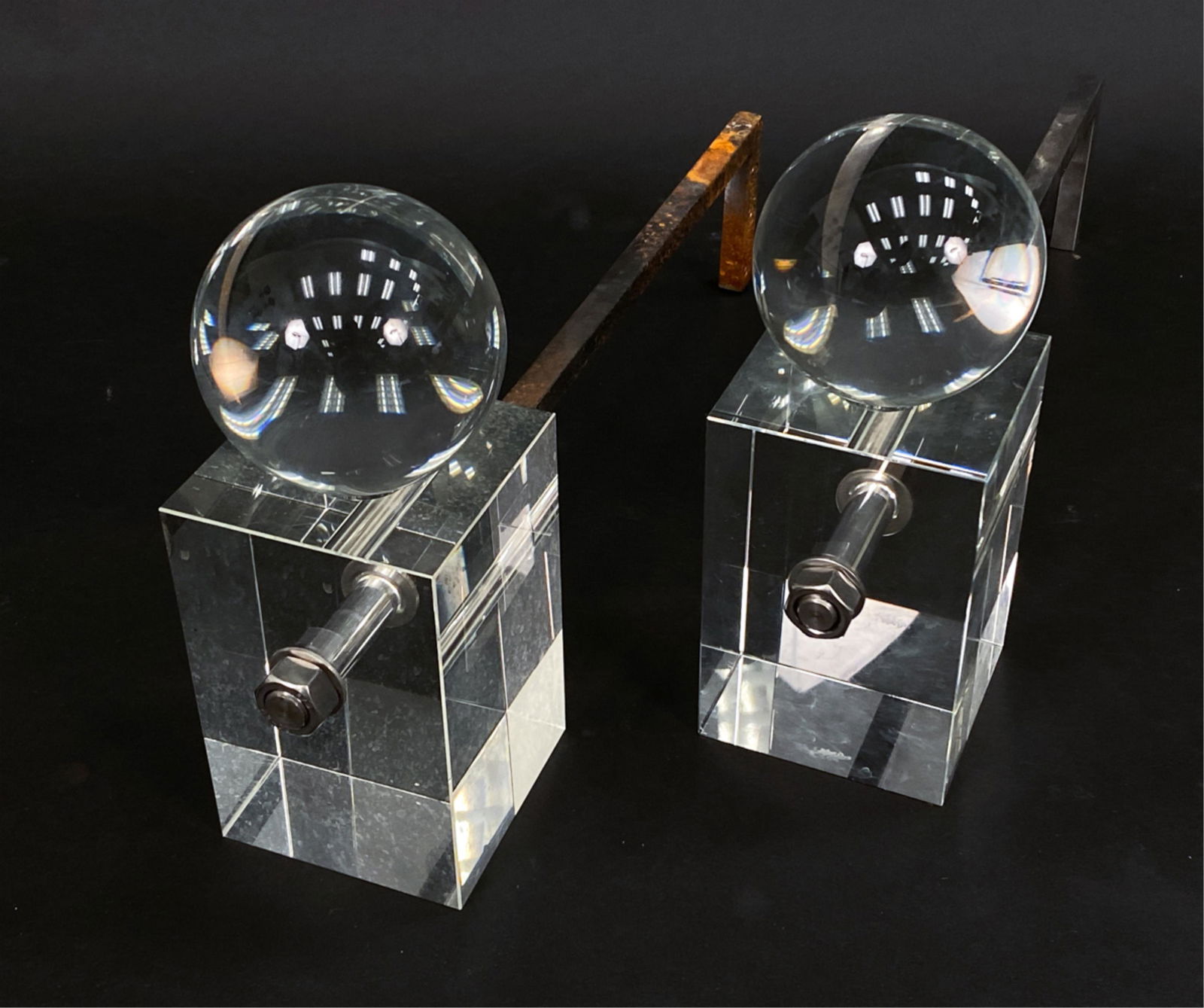 PAIR OF CHESNEY'S LUCITE SPHERICAL ANDIRONS: Geometric form lucite andirons. Marked Chesney's to steel. Dimensions: H 10.25" x W 4" x D 18.5" Condition: Signs of use including some corrosion to steel. One sphere detached from base.