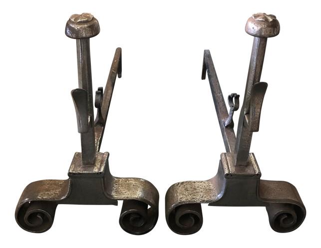 POLISHED STEEL ANDIRONS: Keep wood corralled by your fireplace in style with this pair of andirons. Made from metal, they feature scrolling silhouettes and a silver finish for a twist of glamour. Plus, they’re on the small