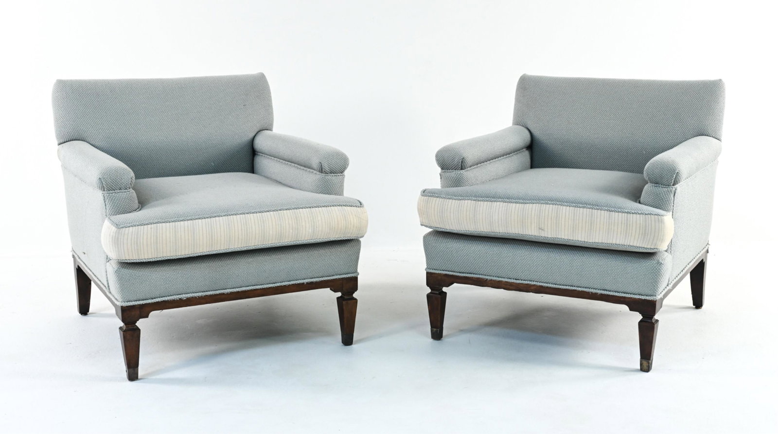 PAIR OF MID-CENTURY CLUB CHAIRS: With later woven upholstery by Tiger Lily; labeled under cushion. Dimensions: H 29.5" x W 29" x D 30" x SH 16.5" Condition: Light fading, a few faint spots of soiling to upholstery; nicks and dings to