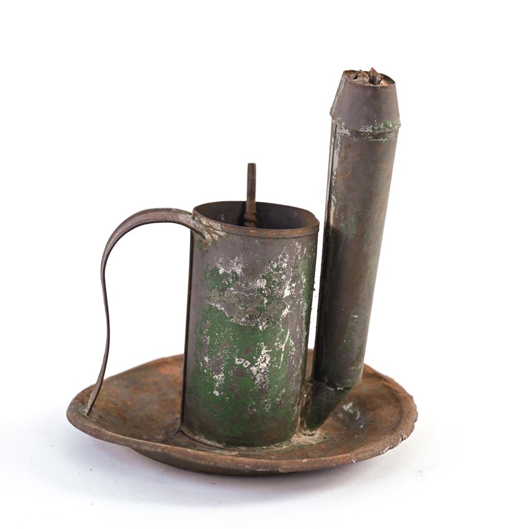 EARLY AMERICAN LARD OIL FINGER LAMP: With remnants of green paint. Dimensions: H 7" x Dia. 7" Condition: Missing lid. Bends to metal, a couple small cracks to edge of drip pan; distressed patina and oxidation consistent with age.