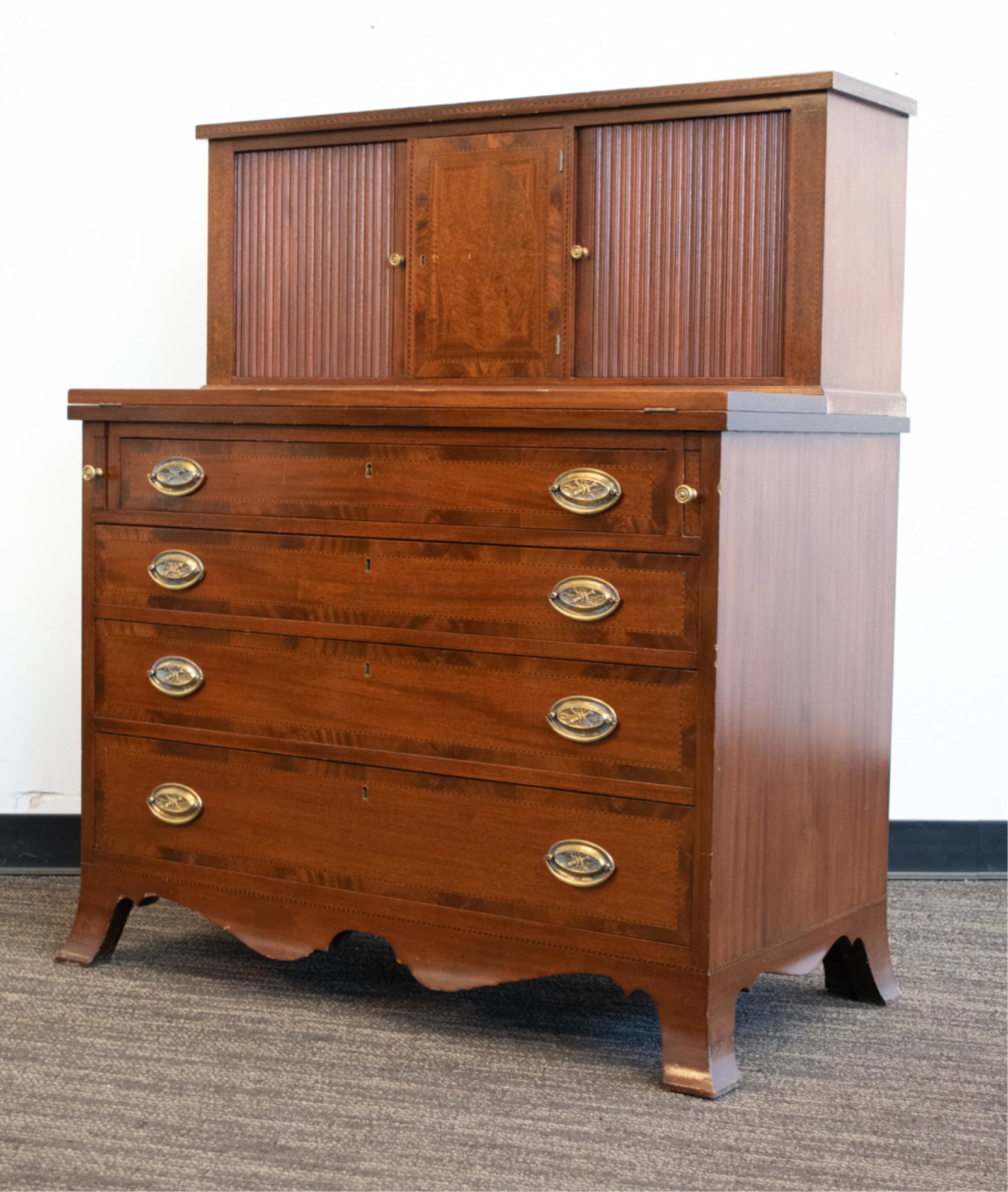 FEDERAL-STYLE INLAID MAHOGANY SECRETAIRE: Vintage, 20th century. With tambour doors to top. No apparent labels. Including key. Dovetailed drawer joints. Dimensions: H 45.75" x W 39" x D 20" Condition: Proper right side tambour door has someth